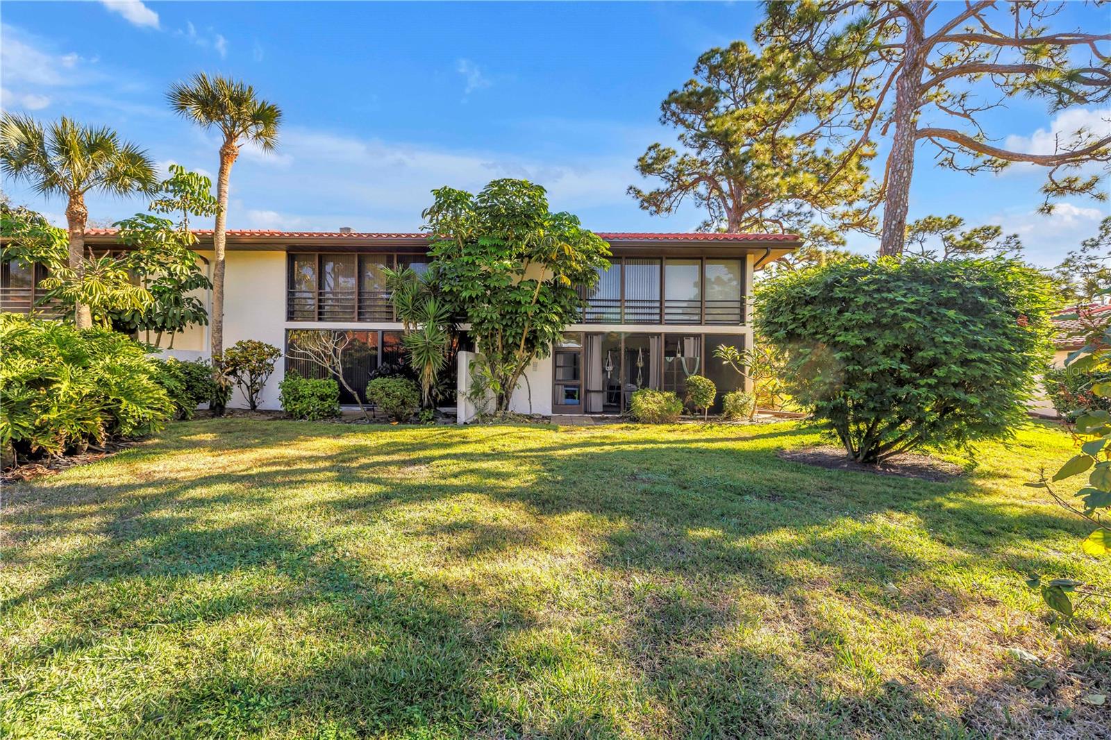 Fully furnished, covered parking right out front and overlooking the community pool, this second-floor condo offers easy Florida living in the well-maintained Valencia community next to IMG Golf Course — with peaceful views and no worries about stray golf balls near your home. Bright and inviting, the layout feels open and comfortable from the moment you walk in. The enclosed Florida room has been opened up to create additional living space filled with natural light, making it the perfect spot for a sitting area, dining space, home office, or simply a place to relax and enjoy the pool view.

The kitchen features granite countertops, plenty of cabinet space, and an easy flow into the main living area, making everyday living and entertaining feel effortless. Both bedrooms have brand-new carpet, giving the home a fresh, move-in-ready feel, and the condo is being sold fully furnished so you can start enjoying it right away.

The split-bedroom layout offers two spacious primary-style suites, each with its own private bathroom, making the setup ideal for guests, seasonal living, or shared living arrangements. At the front of the condo, the enclosed lanai provides extra usable space along with two separate storage closets — a rare feature that’s perfect for beach gear, golf clubs, bikes, or seasonal storage.

Valencia is known for its convenient location close to everything you come to Florida for. You’re just minutes from the beaches of Anna Maria Island, Sarasota-Bradenton International Airport, shopping, restaurants, IMG Academy, and local favorites like Detwiler's Farm Market. Whether you’re looking for a full-time home, winter retreat, or investment opportunity, this condo offers a comfortable lifestyle in a location that’s hard to beat.