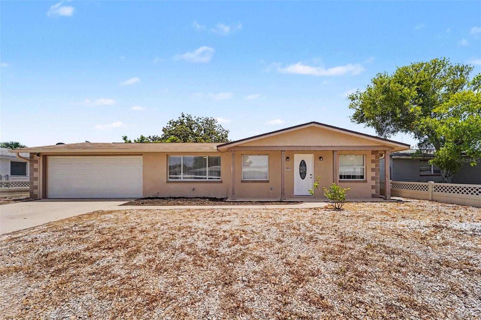 Welcome to this inviting 3-bedroom, 2-bathroom home situated in the desirable Aloha Gardens neighborhood. This home features a seamless, open-concept floor plan that connects the main living spaces and creates a bright, airy atmosphere. The beautifully updated kitchen overlooks the living area and is equipped with stunning granite countertops and sleek stainless-steel appliances. The primary bedroom provides excellent storage with a large walk-in closet. Step outside to enjoy a private, fully fenced-in backyard, offering a perfect space for outdoor relaxation or entertaining. Ideally located in the fast-growing New Port Richey area, this home offers incredible convenience. You are situated close to beautiful beaches, major hospitals, diverse shopping, and local restaurants. The area boasts a relaxing coastal lifestyle where you can consistently enjoy a refreshing breeze from the nearby waters.