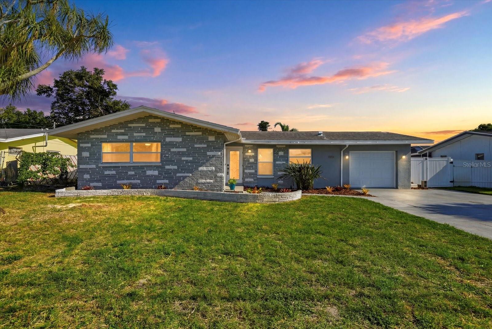 Welcome home to this stunning, fully renovated 3-bedroom, 2-bathroom pool home in the heart of St. Petersburg — where modern updates meet effortless indoor-outdoor Florida living. Located 

Step inside to a completely remodeled kitchen (2 years young) featuring gleaming stainless steel appliances, a gas range, and a showstopping large granite waterfall island — perfect for casual meals or entertaining. Abundant cabinet space keeps everything organized and within reach. Both bathrooms were also fully renovated 2 years ago with stylish, contemporary finishes throughout.

The living room's floor-to-ceiling glass doors open completely to the screened-in pool lanai, blurring the line between indoor and outdoor living. It's an entertainer's dream — host effortlessly as your living space flows right out to the sparkling pool, complete with a brand-new variable speed pool pump and filter for quiet, energy-efficient operation. The setting is complete with a brand-new paver pool deck and lush new turf backyard requiring minimal maintenance.

This home isn't just beautiful — it's smart and efficient too. A fully paid-off solar energy system keeps electric bills under $50/month, while a new tankless hot water heater ensures endless hot water on demand. Located high and dry, this home does not require flood insurance and has not sustained any storm damage. Reclaimed water is also available for just $25/month, giving you unlimited water for gardening and landscaping at a fraction of the cost. Additional upgrades include a new washer and dryer, new garage door, and a roof that's only 10 years old — giving you peace of mind for years to come.

Location doesn't get better than this — just steps across the street you'll find public parks offering tennis, pickleball, and basketball courts, plus a large dog park, perfect for an active lifestyle right outside your door. Plus, you're just 10 minutes to the beach and 10 minutes to Downtown St. Pete, putting the Gulf's sugar sand beaches and downtown's vibrant restaurants, breweries, and arts scene within easy reach.

This move-in ready gem checks every box — renovated kitchen and baths, energy efficiency, low-maintenance yard, resort-style outdoor living, and an unbeatable location. Don't miss your chance to make it yours!