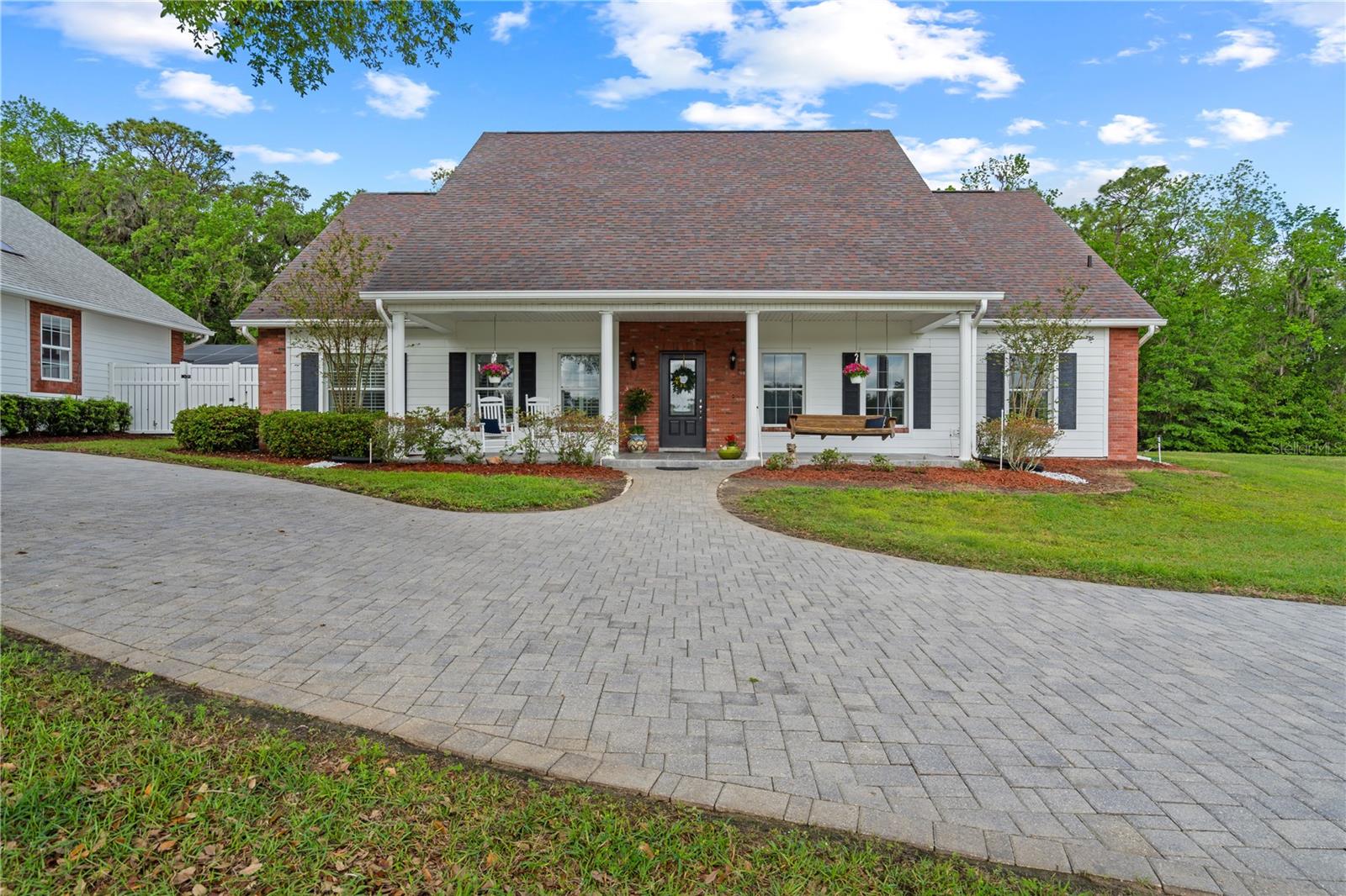 Welcome to this one of a kind, spacious country estate with old Florida charm. As you enter the property through an electronic entrance gate,
you will pass by the large stock pond and gradually make your way through the private, wooded drive, which borders over 300 acres of
protected Hernando County wildlife and preserved land with numerous hiking trails and natural amenities, all within minutes from this sprawling
property. Entering this impeccably maintained 3 bedroom, 2 ½ bath home, there are dramatic cathedral ceilings in Entry, Dining & Living rooms
with a large flagstone fireplace and hearth. The eat in kitchen is a chef’s dream, with floor-to-ceiling custom cabinetry, bay windows and granite
countertops. A spacious center island gives you additional work and eating space, with second sink and a window seat overlooking the front
pasture. The oversized Primary bedroom has two large, custom walk-in closets, a walk-out, screened patio with access to the outside and
attached is a natural-stone tiled bathroom with a walk-in shower, granite countertops and double sinks with separate vanities. There is also a
dedicated home office, a large family room with skylights and a separate laundry room with washer/dryer, mud sink and natural-stone tiled floor.
Other upgrades include ceiling fans in all rooms and on the porch and Bimini shutters and custom draperies throughout the home. In addition to
the attached 2-car garage, other outstanding amenities include a screened porch (1540 sq. ft.), a large barn (1152 sq. ft.) and a newly
renovated in-ground pool (640 sq. ft.) with sun-shelf and enclosure. There is also a detached 4-car garage connected to a finished workshop
(1925 sq. ft.) - Perfect for avid hobbyists or a future large guest suite. This space includes a ½ bath and a fully-decked, standing-room attic
which runs the length of the structure. High & dry location, zoned for agriculture, this all could be your perfect retreat, working farm or just
about anything you could imagine!. Hurry and make an appointment to see this beautiful property before it's gone!