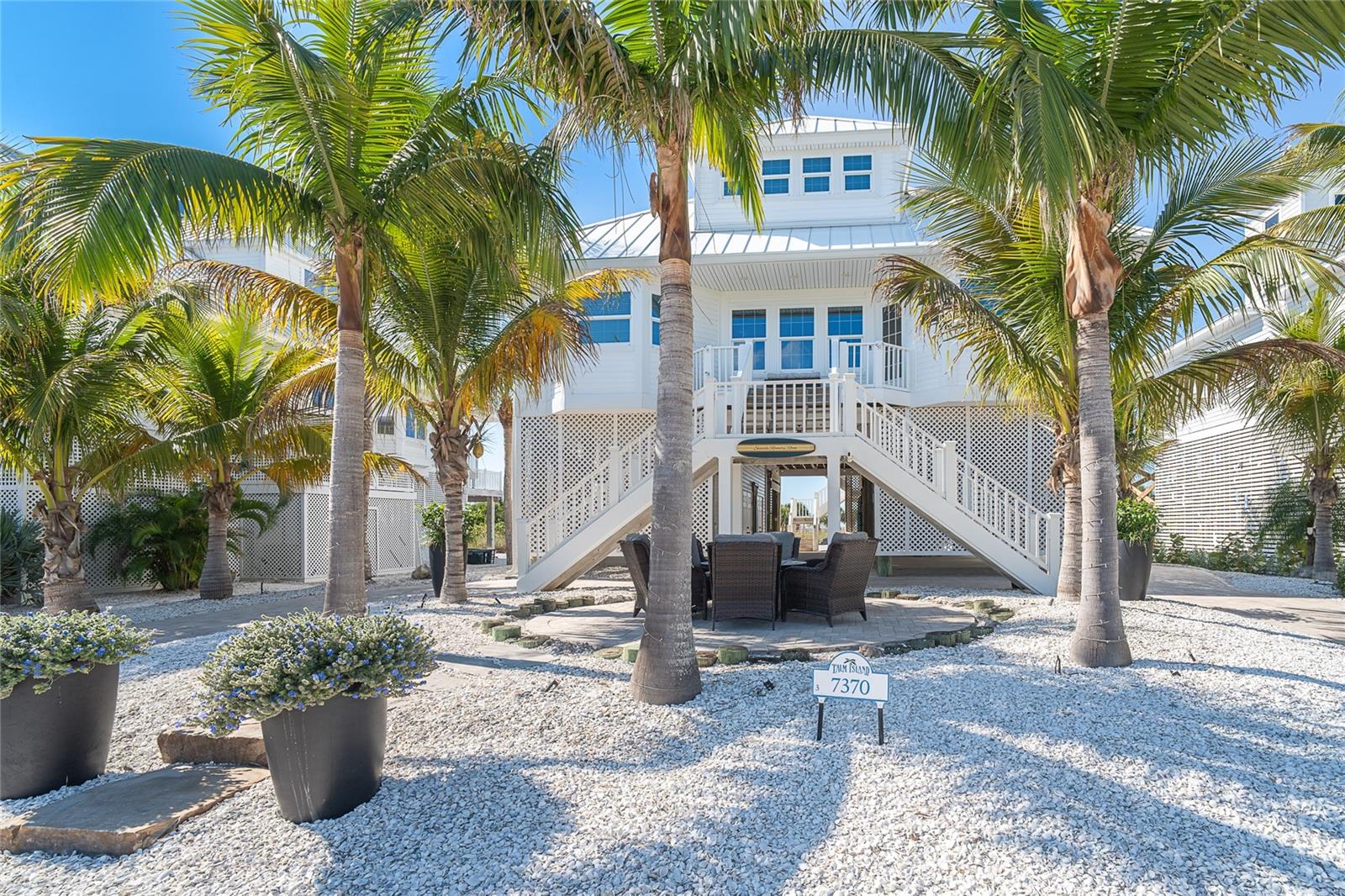 Stunning Gulf-Front Coastal Escape. Discover the rare opportunity to own a premier gulf-front property offering uninterrupted, panoramic views of turquoise waters and sugar sand beaches. Positioned in one of the most desirable stretches of coastline, on a barrier island between Ft. Myers and Sarasota this residence captures the essence of coastal living with its breathtaking sunsets and tranquil ocean breezes. Set amid swaying palm trees and manicured tropical landscaping, this elevated coastal home greets you with a bright, crisp exterior and a classic beach-house silhouette. The wide front staircase leads to a spacious, glass-lined living level designed to showcase natural light and gentle sea breezes. Inside the open concept let's you see the blue water from Living space, Dining and Kitchen. The kitchen boasts countertop bar with plenty of seating Stainless Steel appliances and hard surface counter. Entertain with ease on the Gulf view Lanai or enjoy time below the house. You must see this inviting outdoor gathering area below the home, offering shaded relaxation and a direct sightline through to the sandy path beyond. The property features low-maintenance stone landscaping, elegant potted greenery, and multiple seating areas ideal for entertaining or unwinding after a day on the beach. Find the guest bedroom and additional bedroom/den on the main floor perfect for island visitors. The upper floor holds the primary bedroom suite, and it is sweet! Relax in the soaking tub, put your feet up in sitting area or walk out to the balcony with amazing views. With its serene setting, charming architectural details, and effortless indoor-outdoor flow, this gulf-front property offers the perfect blend of comfort, coastal character, and resort-style living. First option on dock with 16000 lb. lift. Welcome to an exceptional beachfront residence that perfectly captures the essence of island living.
