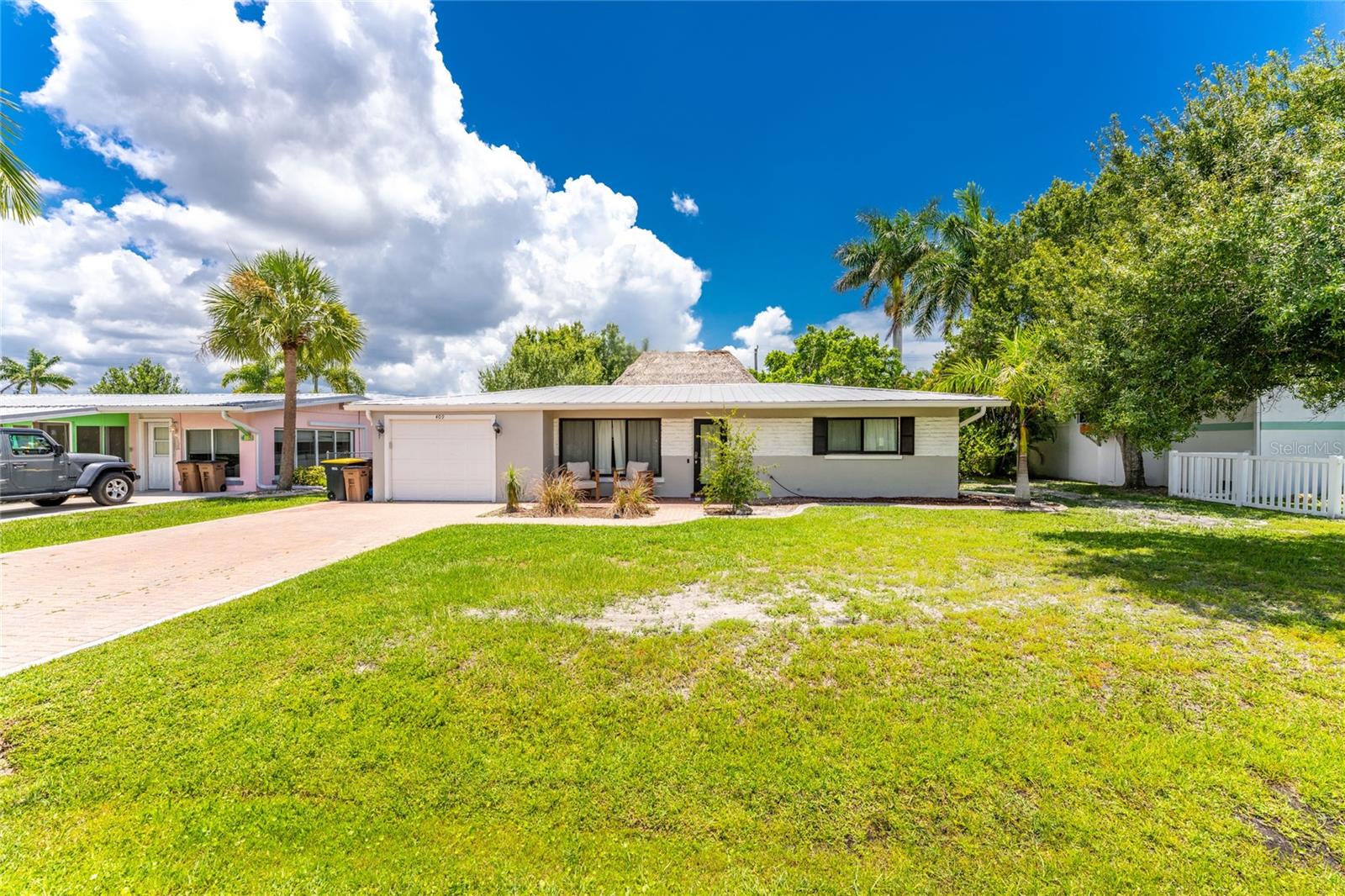 Maximize your investment with this 3-bedroom, 2-bath home located in one of Punta Gorda's most sought-after pockets. Walking distance to the waterfront, downtown, and Fisherman's Village ensures high desirability. The standout feature is the rear alleyway access, providing convenient, flexible entry. The large backyard is primed for development—ideal for adding an ADU, pool, or detached garage. A unique blend of location and future equity growth