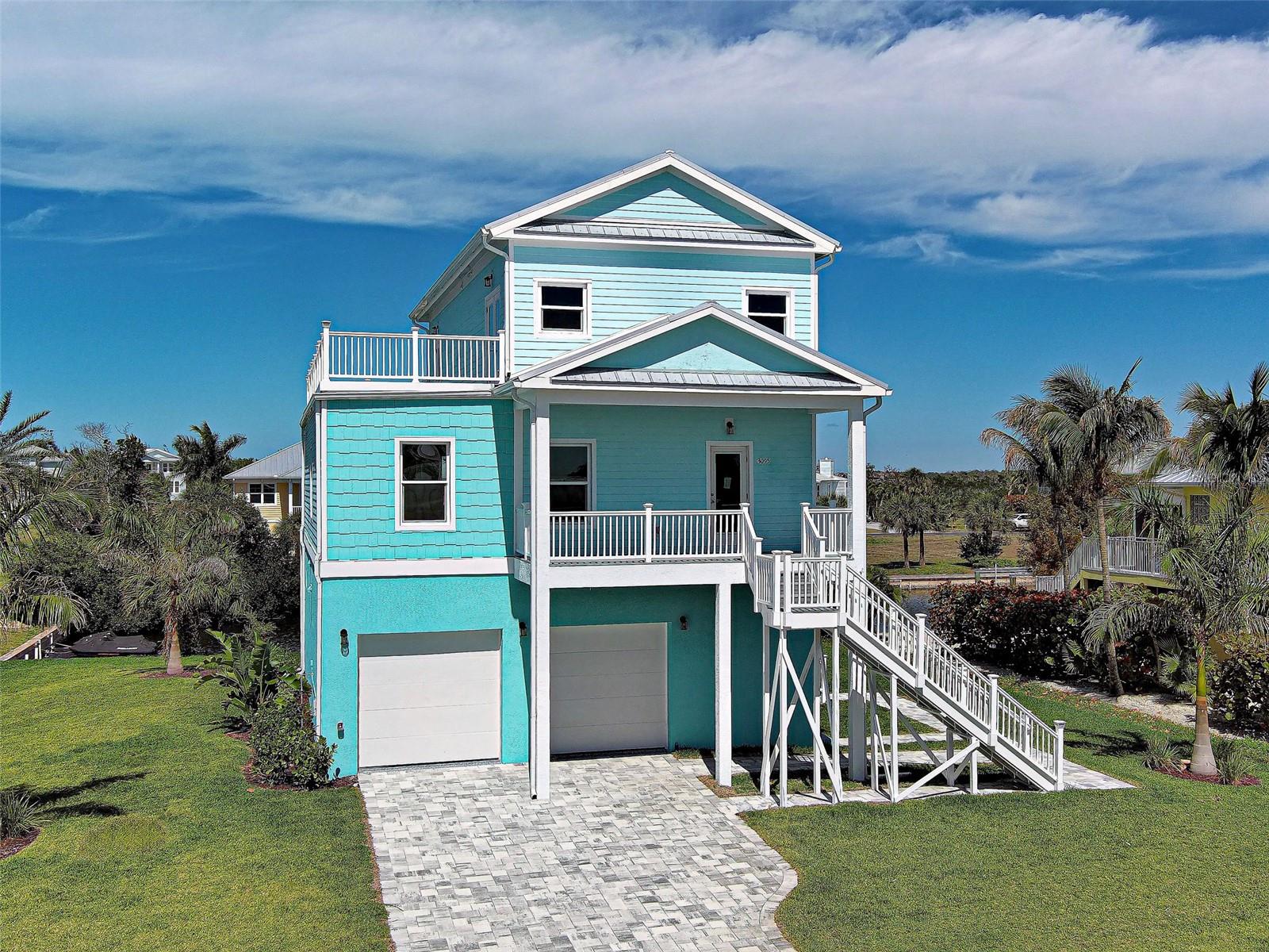 One or more photo(s) has been virtually staged. Experience refined Waterfront Living at Placida Pointe. Located near world-famous Boca Grande, this extraordinary property showcases Breathtaking Panoramic Views of the Intracoastal Waterway & Gulf of Mexico and provides access to resort-style amenities. Come experience this NEW, Custom-Built, Waterfront residence where strength, innovation & luxury design come together. Built with Steel Structural Insulated Panels (SIPs), Steel Beams/Supports, Reinforced Steel Framing, AdvanTech Engineered Subfloors & durable METAL PBR Panel Roof, this home is thoughtfully designed for lasting durability and peace of mind in coastal environments. It's equipped with Hurricane-Impact Insulated Windows/Doors & Insulated HAAS Steel Garage Doors. The garage is finished with a durable Epoxy-Coated floor.  Inside, architectural details shine with a stylish staircase featuring Poplar L.J. Smith Stairs and a private 3-story Traction ELEVATOR. The home features a GAS/PROPANE Range, Dryer & Tankless Water Heater. 2 Mitsubishi Electric Mini Split Ductless Heat Pumps/22 SEER with 6 zones provides efficient, quiet climate control throughout the home. The 1st floor offers a PRIVATE living space/In-Law Suite with SEPARATE ENTRY & KITCHENETTE. A conveniently located Laundry Closet, Bathroom, Bedroom and Bonus Room provide added living space. Step outside to the 1st of 3 spacious decks overlooking the canal–perfect for enjoying the coastal breeze while relaxing or entertaining. The expansive 2nd Floor Kitchen is designed to be the heart of the home, featuring a large Center Island. QUARTZ countertops & premium Schuler Cabinetry provide both durability & a sleek modern look, complemented by Stainless Steel Appliances from Whirlpool. An Apron-Front Sink adds style while the large Walk-In Pantry offers abundant storage. Nuvelle Luxury Vinyl Plank Flooring is featured in all living areas. Custom touches include a Built-In Entertainment Center & soaring ceilings. The 3rd floor showcases a luxurious Primary Suite that offers privacy & space, creating a peaceful sanctuary where you can enjoy Scenic Harbor and SUNSET VIEWS from your PRIVATE BALCONY! The Primary Bath includes a large Walk-In Shower and Double Vanity. The MB has 2 ample Walk-In Closets. Spa-Inspired Bathrooms include Walk-In Showers/Waterproof Surrounds, Delta Fixtures, Rain Showerheads with relaxing Shower Jets. Just steps from the bedroom is a private BONUS ROOM, ideal for a home office, den or quiet lounge. The curb appeal is unmatched with a Flagstone Paver Driveway, Professional Landscaping, 4 Royal Palms and Florastsan Sod. A Rainbird & Hunter Sprinkler System ensures proper hydration.  A WaveArmor Floating Dock & Concrete Seawall grants canal access for kayaks/shallow draft boats to Coral Creek. Just ½ mile away is the newly renovated Placida Harbour Clubhouse and Private Marina that can accommodate larger boat access. There are 2 other Clubhouses, Heated Pools, Fitness Center, Tennis Courts, Pickleball, and much more! Residents and guests can enjoy the PRIVATE FERRY to Placida Beach/Little Gasparilla Isle with a 10-minute boat ride! Members have access to Placida Beach Clubhouse complete with Pool/Kitchen & 7 miles of Pristine Beaches accessible ONLY by boat. Just minutes from Boca Grande, Beaches, Shops, Dining, Coral Creek Golf Club & Coral Creek Private Airport, this gated waterfront community offers privacy & the tranquil luxury of waterfront living. Don’t Wait~Make this piece of paradise yours today!