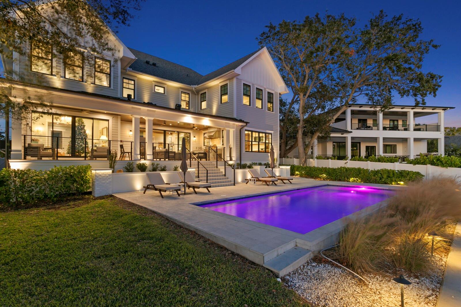 Located in the Poet’s Corner of South Tampa, this 6,479 square foot, 6-bedroom, 6.5-bathroom waterfront estate redefines modern luxury. Built in 2023 by local builder, Sunset Properties, the home is a perfect blend of cutting-edge technology and exquisite craftsmanship throughout. Features include a state-of-the-art Control4 system that seamlessly manages in-ceiling speakers, four climate zones, lighting, and a Protect security system with seven outdoor cameras. Hurricane-rated Marvin windows and sliders, remote-controlled blinds. The European oak flooring throughout the home adds both elegance and functionality. Custom Closets-by-Design storage solutions are found in every bedroom, as well as in the pantry, laundry, and hall closets, ensuring every space is as practical as it is beautiful. An open living concept captures views of the water from all main areas of the home. The chef’s kitchen is equipped with Subzero, Wolf, and Cove appliances, quartz countertops, 36” farm style sink, and a pot filler over the dual-fuel range with double ovens. Although new construction, a bit of Tampa's history resides in this home. The pantry door, from Schiller’s architectural salvage, was an original door from the Tampa Courthouse office of Judge Mark A. Pizzo. The family room is anchored by a natural stone gas fireplace, while the dining room features custom cabinetry, a bar sink, icemaker, and a wine refrigerator. The main level media room offers a true cinematic experience with remote blackout shades, an 83-inch Sony Bravia TV, and high-end surround sound. The thoughtfully designed layout includes a full in-law suite on the first level. The second level primary suite has an expansive walk-in closet with center island and windows for natural light. The spacious primary bath has a zero-entry shower, free standing bathtub, dual vanities and custom cabinetry.  Additional bedrooms, all located on the second level, feature en-suite bathrooms and walk-in closets. To slow down at the end of the day, step outside to your private oasis. The covered lanai has an Espresso stained tongue in groove plank ceiling with remote control fans. The full outdoor kitchen with Wolf appliances will bring out your inner grill master. Ignite the fireplace, relax and enjoy. An 11’x 36’ saltwater pool, with a sun shelf, is perfectly placed overlooking open waters. The extended height seawall, built in 2022, private dock with Trex decking, and 10,000 lb capacity boat lift with new stainless steel motors make this property ideal for waterfront living. Additional amenities include laundry on both first and second levels, a whole-home water filtration system, two Rinnai tankless water heaters, a 24kw whole house Generac natural gas generator, and an attached three-car garage with epoxy flooring and 35-foot ceilings. Perfectly situated in a premier location within the Dale Mabry/Coleman/HB Plant school district, and minutes to both the Downtown Tampa and Westshore business districts, Channelside and Waterstreet. This home offers an unparalleled lifestyle of elegance, comfort, and sophistication. We look forward to seeing you.