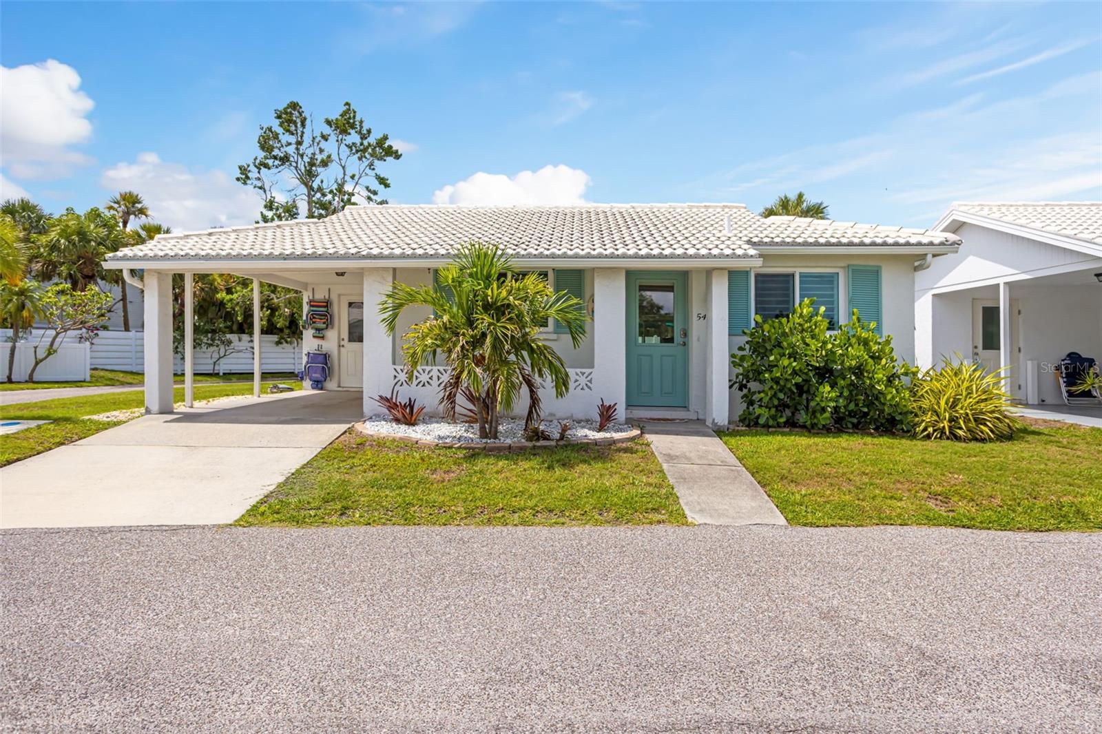 Tucked within the waterfront community of Spanish Main Yacht Club on the north end of Longboat Key, this fully renovated detached villa offers a timeless coastal flair just steps from the beach. A true hidden gem and slice of paradise, residents enjoy private deeded beach access to the Gulf of America, a deep water marina with affordable boat slips, and the ultimate boating lifestyle with easy access to waterfront restaurants and open waters. This light and bright 2-bedroom, 2-bath residence is being offered turnkey furnished. Featuring an open floorplan with luxury vinyl plank flooring, impact windows and doors, custom window shades throughout, and a spacious Florida room ideal for additional living or entertaining space. The beautifully updated kitchen showcases quartz countertops, stainless steel appliances, abundant custom cabinetry with soft-close drawers, and a large seating island perfect for gathering. Additional highlights include an interior laundry room with stackable washer and dryer, water softener system, stone paver patio, covered parking, and private driveway. Spanish Main Yacht Club is a vibrant and active 55+ community offering a heated waterfront pool, shuffleboard, social events, pet-friendly policies, maintenance-free living, and one of the most desirable 40-slip marinas on Longboat Key. Ideally located just minutes from St. Armands Circle, Sarasota, and Anna Maria Island, this exceptional Longboat Key retreat is ready for immediate enjoyment.