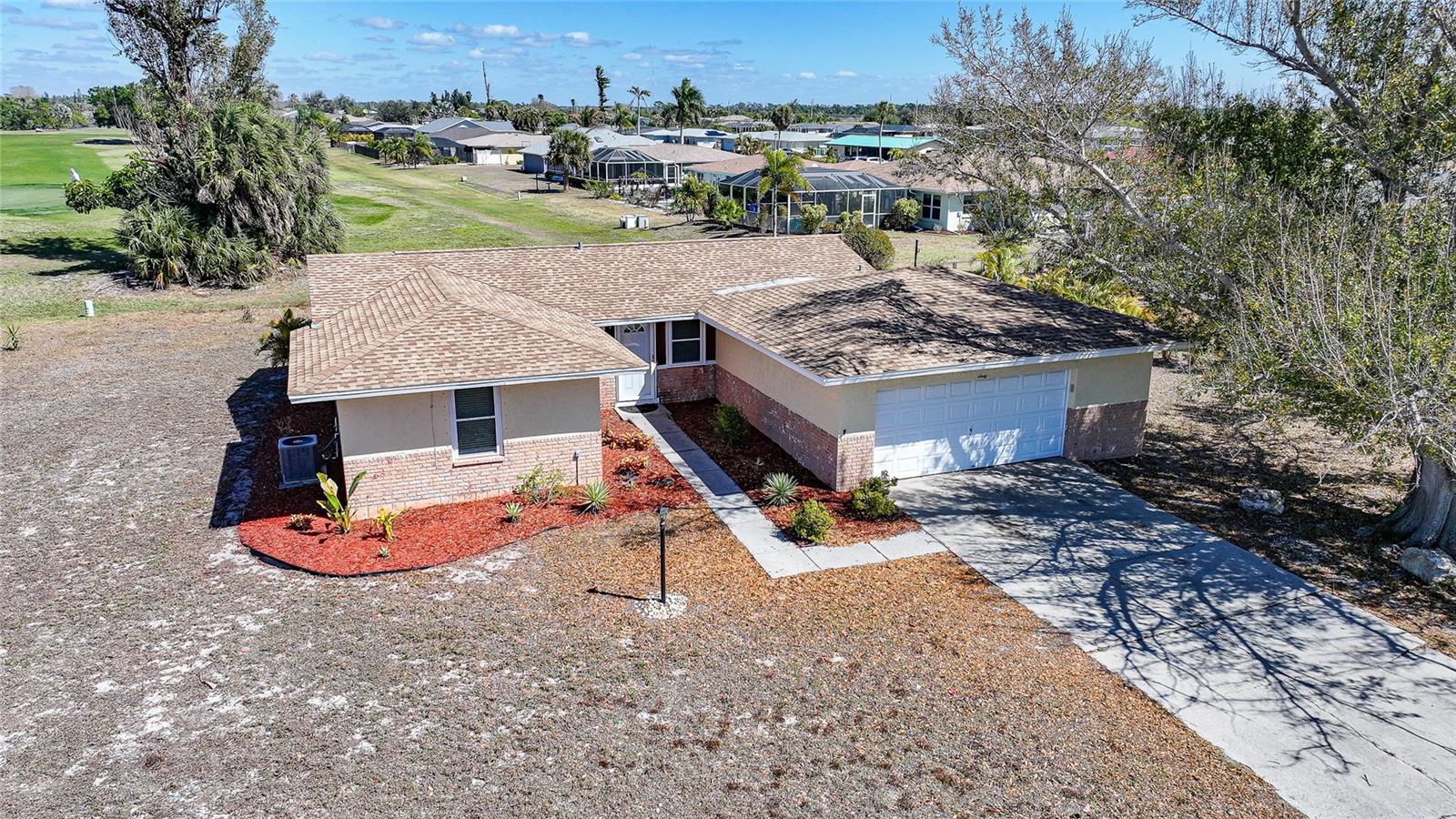 One or more photo(s) has been virtually staged. Welcome to your next chapter in Rotonda West's PREMIER GOLFING COMMUNITY! This 3-bedroom, 2-bathroom home with a two-car garage sits on over a QUARTER ACRE with direct golf course views, offering an unbeatable combination of location, lifestyle, and value. Step inside to discover recently updated luxury vinyl plank in the living/dining areas and tile flooring throughout the rest of the home, complemented by modern recessed lighting. The bright, open kitchen features generous cabinet space and flows seamlessly into the dining area—perfect for daily living and entertaining. The spacious living room opens to an expansive backyard with room to add your dream pool while enjoying front-row views of the fairway. The primary suite provides a private retreat with an en-suite bathroom and walk-in closet.  Two adjacent bedrooms are perfect for a growing family, guests or home office!  Recent upgrades include a newer roof, AC unit with updated ductwork, and hurricane fabric panels for added protection and peace of mind. Rotonda West offers an exceptional Southwest Florida lifestyle, nestled between Englewood and Port Charlotte with access to five golf courses totaling 99 holes. The community features walking and biking trails, a 165-acre park, tennis and pickleball courts, and a playground with pavilion. Pristine Gulf beaches at Manasota Key and Boca Grande are minutes away, while fishing, boating, and kayaking opportunities abound. Explore charming downtown Punta Gorda or Dearborn Street in Englewood for local shops, restaurants, and farmers markets. Convenient to local and regional airports. Low annual HOA fees and city water/sewer services complete this exceptional opportunity—ideal for investors, first-time buyers, or those seeking a seasonal retreat.