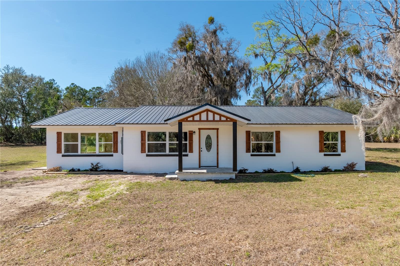 Beautiful home on just over 3 acres of land! Spacious and updated, this 3 bedroom 2 bathroom home has all of the modern luxuries you could ask for. Brand new kitchen, stainless appliances, new flooring, new windows, new paint inside and out, a show stopping new metal roof and so much more! Perfect location for those commuting to Palatka, Ocala or Gainesville. You don’t want to miss this cute house up on a hill! Schedule your showing today.