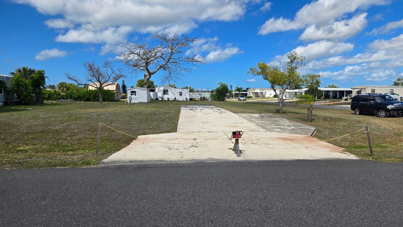 This is a great place to make you new home. This oversized lot in Holiday Mobile Estates offers you as little or as much as you would like.  There is a very active club (Edgewater) with a heated and clilled swimming pool, club house with many, many activities, tennis, pickleball, shuffleboard plus more.  The Gulf of America is only three mile away with four beautiful beaches.  Near buy there is shopping, restaurants, medical facilities, golf courses, boat launches, fishing and the list is endless.  Hope to see you soon.