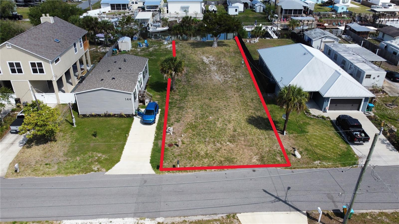 Virtually Staged. Tucked between the laid-back charm of New Smyrna Beach and the energy of Cape Canaveral, this 50x176 deep-water canal lot in Oak Hill offers a rare opportunity to build the waterfront lifestyle you have been envisioning, at an attainable price point. With direct access to the Intracoastal Waterway and the world-renowned Mosquito Lagoon. The canal accommodates a 24-foot center console, sailboat, or pontoon boat, and has an existing concrete seawall already in place. New canals are no longer being cut in Florida, making established canal-front lots like this one increasingly scarce and valuable. The lot sits above sea level with no flood concerns, and there is no HOA to limit your vision.

Everything you need to break ground is already in place: impact fees are paid, and public water, sewer, and electric are connected and ready. Engineered and sealed house plans by a licensed Florida professional engineer are available for a thoughtfully designed 3-bedroom, 2-bath home featuring 1,652 square feet under air, a 2-car garage, and a board-and-batten/stucco exterior on CMU construction. Zoned MH-5, which permits both manufactured and site-built homes. The city allows an RV on-site while your new home is under construction, so you can be present for the build without sacrificing comfort. New homes are already rising in the neighborhood, making now the right time to secure your place on the water.

Please note: select listing photos are AI-generated conceptual renderings created to illustrate the potential of this lot with a completed home and pool; they are not photographs of existing structures.
