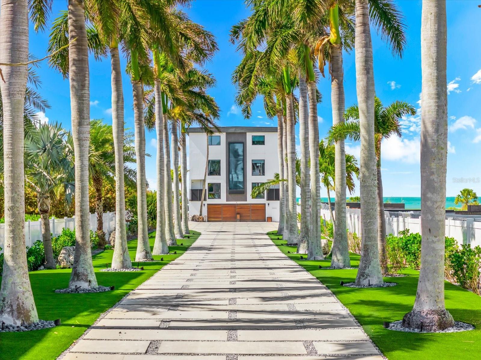 Experience one of the most extraordinary waterfront settings on the coveted North End of Anna Maria Island, just moments from the world-renowned shores of Bean Point. Set on over an acre of Gulf-front beachfront land, this rare estate provides exceptional privacy, expansive shoreline, and breathtaking panoramic views of the Gulf of Mexico.

In 2019, the property underwent a comprehensive structural and architectural redevelopment that transformed the residence into a modern coastal estate, including major infrastructure upgrades such as updated electrical, plumbing, and HVAC systems, along with new flooring, custom millwork, redesigned bathrooms, cabinetry, lighting, and modern coastal finishes throughout.

Originally constructed as an elevated coastal residence, the home was extensively expanded, redesigned, and structurally reimagined to create a three-level retreat designed for elevated island living. The redevelopment included the addition of a private master suite level, construction of a large elevated pool and entertainment deck, and installation of a dramatic three-story architectural water feature, while completely reconfiguring the interior floor plan.

Privately gated and approached by a palm-lined drive, the residence welcomes you with a striking 20-foot waterfall entry. Expansive windows capture nearly 270-degree Gulf views, filling the open living spaces with natural light and coastal breezes. The main living areas flow seamlessly to spacious outdoor terraces finished in Brazilian Walnut (IPE) decking—ideal for sunset entertaining overlooking the Gulf.

The chef’s kitchen features custom rosewood cabinetry, three ranges, three ovens, a built-in coffee bar, wine refrigeration, and premium Sub-Zero, Wolf, Cove, and Miele appliances. Multiple bedroom suites include ensuite baths and water views, while a dedicated entertainment level features shuffleboard, a poker table, pool table, and lounge space.

The top-floor owner’s retreat, accessible by elevator, captures sweeping Gulf views and includes oversized walk-in closets, a private coffee bar, and a spa-style bath with soaking tub and rain shower.

Outdoor amenities include a heated ozone saltwater pool with lap feature, elevated entertainment deck, private gym, infrared sauna, and a two-car garage with additional golf cart space. Direct beach access leads to one of the most peaceful stretches of shoreline on Anna Maria Island.

Located near the shops and restaurants of Pine Avenue, this property is a rare opportunity to own a fully transformed Gulf-front estate on over an acre of beachfront land on the North End of Anna Maria Island.