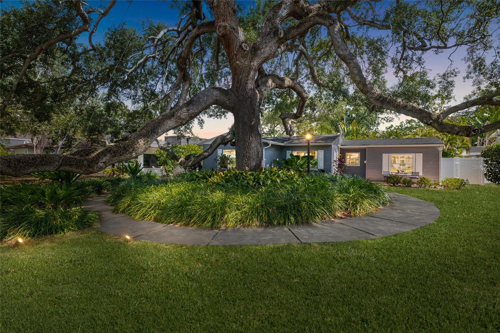Welcome to 4217 W Morrison Ave — a beautifully updated 1950 single-story gem in the heart of coveted Beach Park! Shaded by one of South Tampa’s most magnificent oak trees, this 3-bedroom, 2-bath, 1,835 sq ft home blends classic charm with major recent upgrades.

Inside, parquet and Saltillo tile floors lead through a split floorplan designed for both everyday living and entertaining. The formal living and dining rooms exude timeless style, while the spacious family room — anchored by a wood-burning fireplace and built-in bookshelves — opens through glass garden doors to your private backyard oasis. The kitchen features a large island with a brand-new cooktop and pool views through its own glass garden doors.

The massive primary suite boasts engineered hardwood floors and, thanks to new front-of-home plumbing, offers exciting potential to add a large en-suite bath.

Step outside to a true Florida retreat: a large pool with pavered deck, lush tropical landscaping, a huge covered lanai, and a covered wooden deck — perfect for relaxing or entertaining year-round. A detached workshop with power and A/C adds incredible flexibility for hobbies, storage, or a home office, plus a 1-car carport for convenience.

Major 2022 updates include new plumbing to the sewer line, new shingle and flat roof, and a new electrical panel  Plus a brand-new 2026 hot water heater for extra peace of mind. Located in the sought after Dale Mabry, Coleman, and Plant school district, this is Beach Park living at its finest — schedule your private showing today!