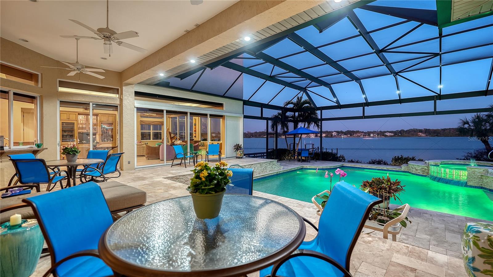 Set on nearly a full acre with 214 feet of direct bay frontage, this Manasota Key waterfront estate offers a rare bay-to-Gulf lifestyle, combining deep-water boating access with deeded beach access just across the street. Positioned along a quiet stretch of Manasota Key Road, the property delivers privacy, scale, and unobstructed water views across Lemon Bay.
Built in 2001 by Newport Home Builder, the residence spans more than 5,200 square feet across two living levels and has been meticulously maintained with thoughtful updates, including a new tile roof in 2024 and new impact-rated garage doors serving the oversized four-car garage. Impact glass windows and sliders throughout the home frame the bay while enhancing storm protection and energy efficiency.
The main living level is designed for everyday comfort and entertaining. Diagonal tile flooring connects the living room—opening directly to the screened bayfront lanai—with the formal dining area and expansive kitchen. The chef’s kitchen features solid-wood cabinetry, granite countertops, center island, breakfast bar, informal dining space, and walls of glass that open to the covered patio and summer kitchen. The adjacent family room enjoys panoramic bay views and seamless outdoor connection.
The primary suite is located on the main level, offering a private retreat with a stone-encased fireplace, morning kitchen, custom walk-in closet, en-suite bath, and direct access to the bayfront patio. Two additional guest suites, a dedicated office or study, and a laundry room complete the first floor.
Upstairs, guests enjoy a loft-style sitting area, a spacious bedroom suite overlooking the bay (large enough to also be a primary suite), and a fifth bedroom currently used as an additional office—providing flexibility for multi-generational living, work-from-home needs, or extended stays.
Outdoor living is a defining feature. The panoramic screened pool deck, completed with travertine flooring, surrounds a resurfaced PebbleTec pool and raised spa, creating a comfortable setting for waterfront entertaining. Boating enthusiasts will appreciate the deep-water dock, updated in 2016 and equipped with a boat lift, electric, and water—offering no fixed bridges and direct access to open bay waters and the Gulf of Mexico. Beach access is conveniently located just across the street.
Ideally positioned on Manasota Key, this estate offers quick access to local waterfront dining, marinas, and nature preserves, while remaining close to Englewood, Venice, and Sarasota’s Cultural Coast. Championship golf courses, shopping, and dining are nearby, with world-class beaches lining both Manasota Key and nearby barrier islands.
A rare opportunity to secure a direct bayfront property with beach access, acreage, and deep-water boating—delivering the best of Southwest Florida coastal living.