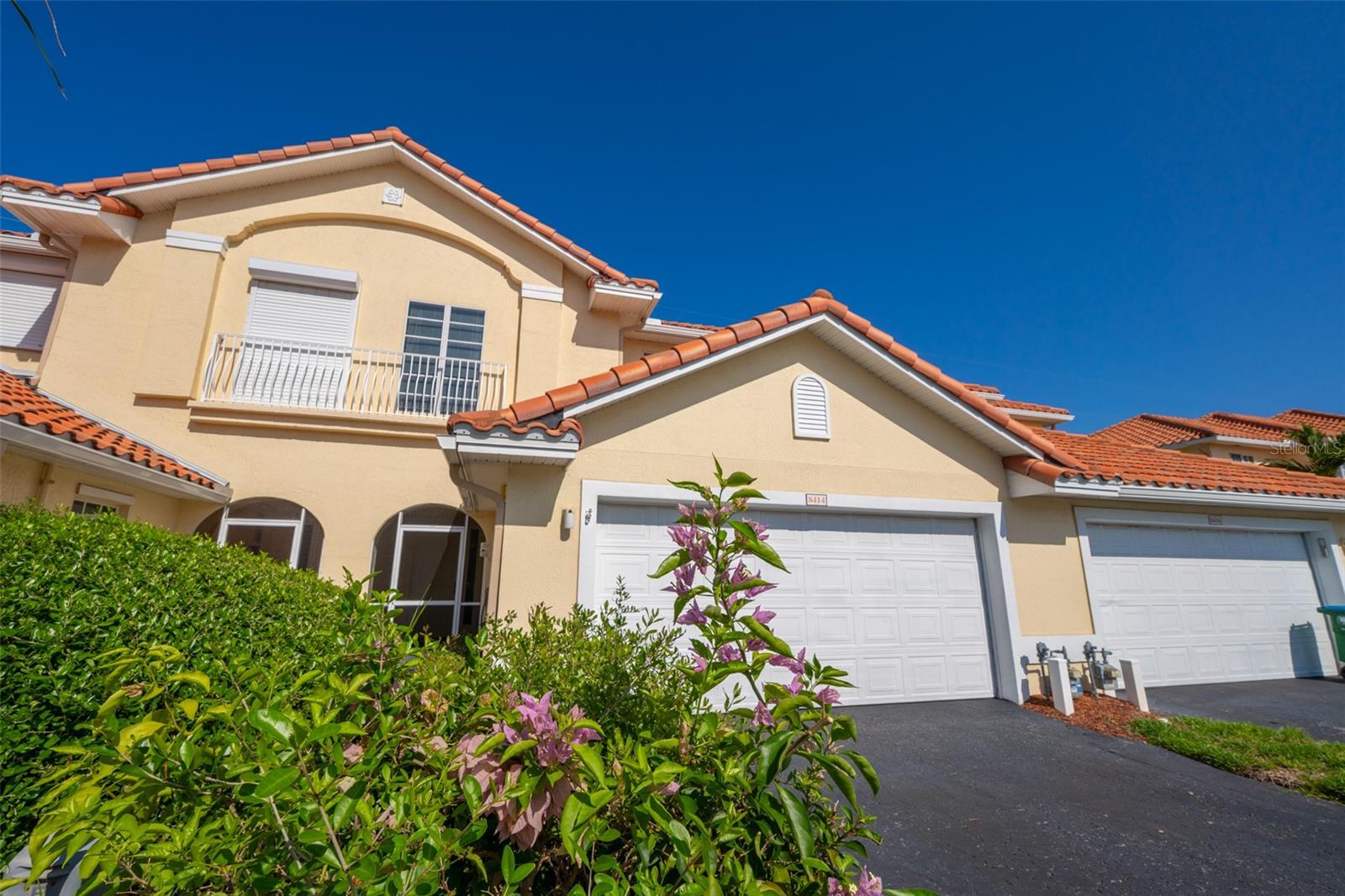 Discover upscale coastal living in this remarkable 4-bed, 2.5-bath townhome in the gated, Mediterranean-inspired Perlas Del Mar community! Spanning 2,300+ sq ft, the open great room impresses with soaring ceilings and oversized sliding glass doors opening to a private screened patio. The main-floor primary suite boasts dual closets with a generous walk-in and a spa like en-suite bath with jetted tub and separate walk-in shower. Upstairs, a loft-style bonus room serves perfectly as a home office or second living area. The chef's kitchen shines with solid wood cabinets, all-new matching 2025 appliances, ample counter and storage space, and a casual dining nook. Elevated finishes include vaulted 10' ceilings, stunning wood flooring and sleek oversized tile. Upgrades include: 6/2026 HVAC, 2025 water heater, central vacuum and hurricane-impact windows/doors. The attached 2-car garage and laundry room offer extra storage and convenience. Perlas Del Mar residents enjoy a sparkling pool, spa, and elegant clubhouse set amid manicured grounds -- creating a serene, upscale retreat. Perfectly positioned between the Atlantic Ocean and Intracoastal Waterway, Perlas Del Mar sits just 2 minutes from Port Canaveral and 4 minutes from pristine beaches and the river. Kennedy Space Center, local parks, golfing, and vibrant dining and shopping are all within easy reach. With convenient access to both Melbourne and Orlando airports and attractions, this location truly delivers it all. Come experience coastal Florida living at its finest!