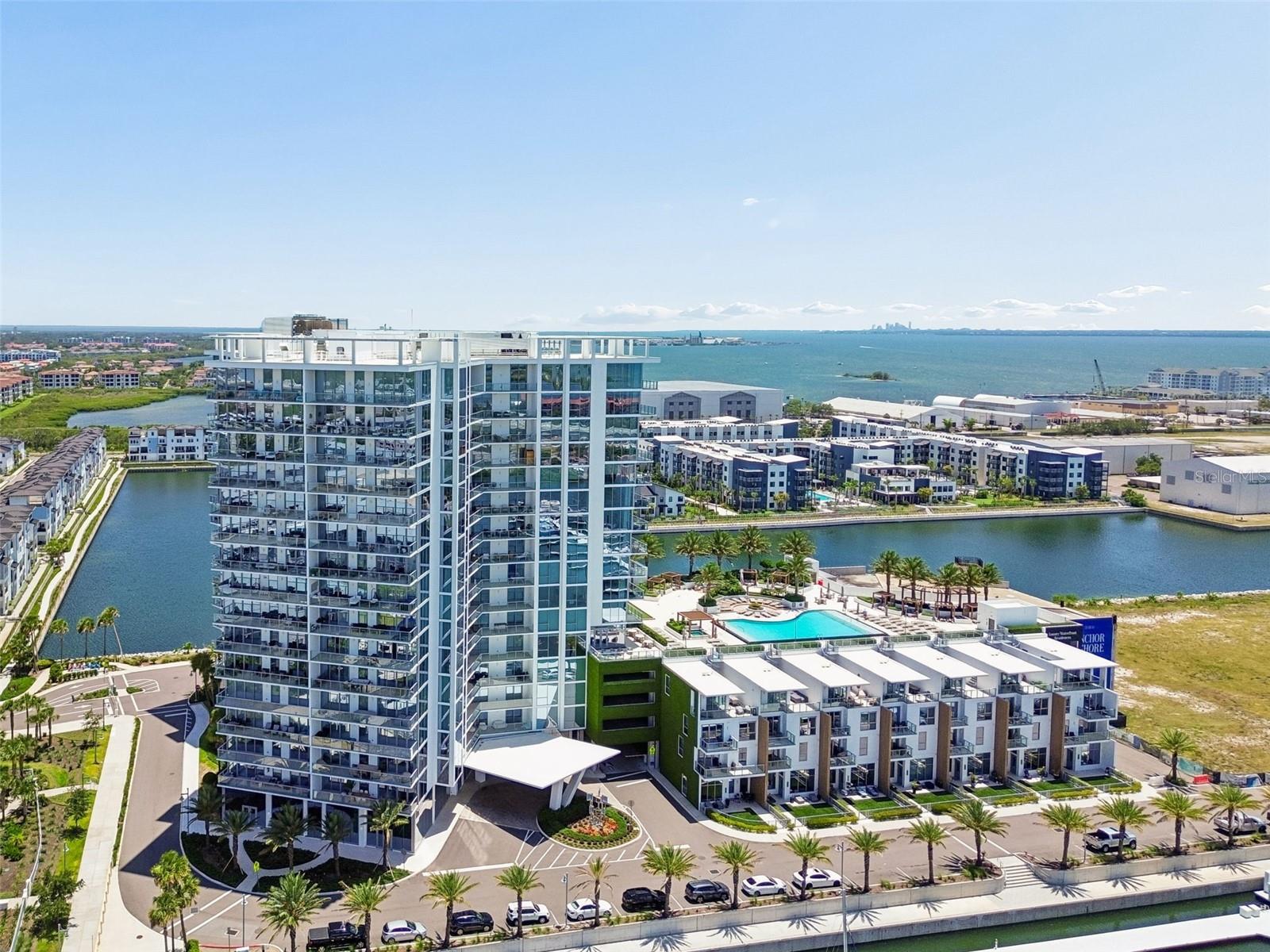 Experience Marina Pointe at its finest in this exquisitely customized residence where luxury, design, and waterfront living converge. Located on the 11th floor of South Tampa's premier waterfront tower, this grand 4-bedroom, 3.5-bath residence spans over 3,000 square feet. With dramatic floor-to-ceiling glass windows and sliders, a 38-foot west facing balcony that showcases breathtaking views of Old Tampa Bay, the marina, and the St. Petersburg skyline. Originally delivered as new construction in 2023, this residence has since undergone an extensive transformation and premium custom upgrades. Arrive via your semi-private elevator to a private foyer and immediately appreciate the sophisticated designer aesthetic. Throughout the residence, the original faux wood tile and carpet have been replaced with 24” X 24” modern tile, creating a seamless and contemporary feel. The spacious open-concept floor plan is anchored by a gourmet chef's kitchen featuring European-style cabinetry, waterfall-edge quartz countertops, and premium Sub-Zero and Wolf appliances. The luxurious owner's retreat offers a 25-foot balcony with south facing water views, a spa-inspired bath with soaking tub, wet room shower, large vanity with built-in drawers added, and an extraordinary custom California Closets wardrobe system. The laundry room has also been completely customized with cabinetry featuring illuminated built-ins. Additional enhancements include designer wallpaper installations, upgraded lighting throughout, custom wood surround for the living room tv, automated shades in every room and carefully curated finishes that create a refined, magazine-worthy interior. The two expansive covered balconies provide the perfect setting for entertaining or enjoying spectacular sunsets over Tampa Bay. Some furnishings are negotiable, presenting a rare turnkey opportunity. Marina Pointe residents enjoy world-class amenities including a 24-hour attended lobby and concierge, resort-style waterfront heated pool and spa, state-of-the-art fitness center, golf simulator, social lounge, spa and massage rooms, dog park, and access to one of Tampa Bay's most impressive private marinas with deep water boat slips available to purchase by residents only. Situated within the vibrant Westshore Marina District, residents enjoy walkable access to waterfront dining, shopping, and entertainment while remaining minutes from Downtown Tampa, Hyde Park, Tampa International Airport, St. Petersburg, and the Gulf beaches. This is not simply a Marina Pointe residence—it's one of the most thoughtfully upgraded and beautifully finished units in the building.
