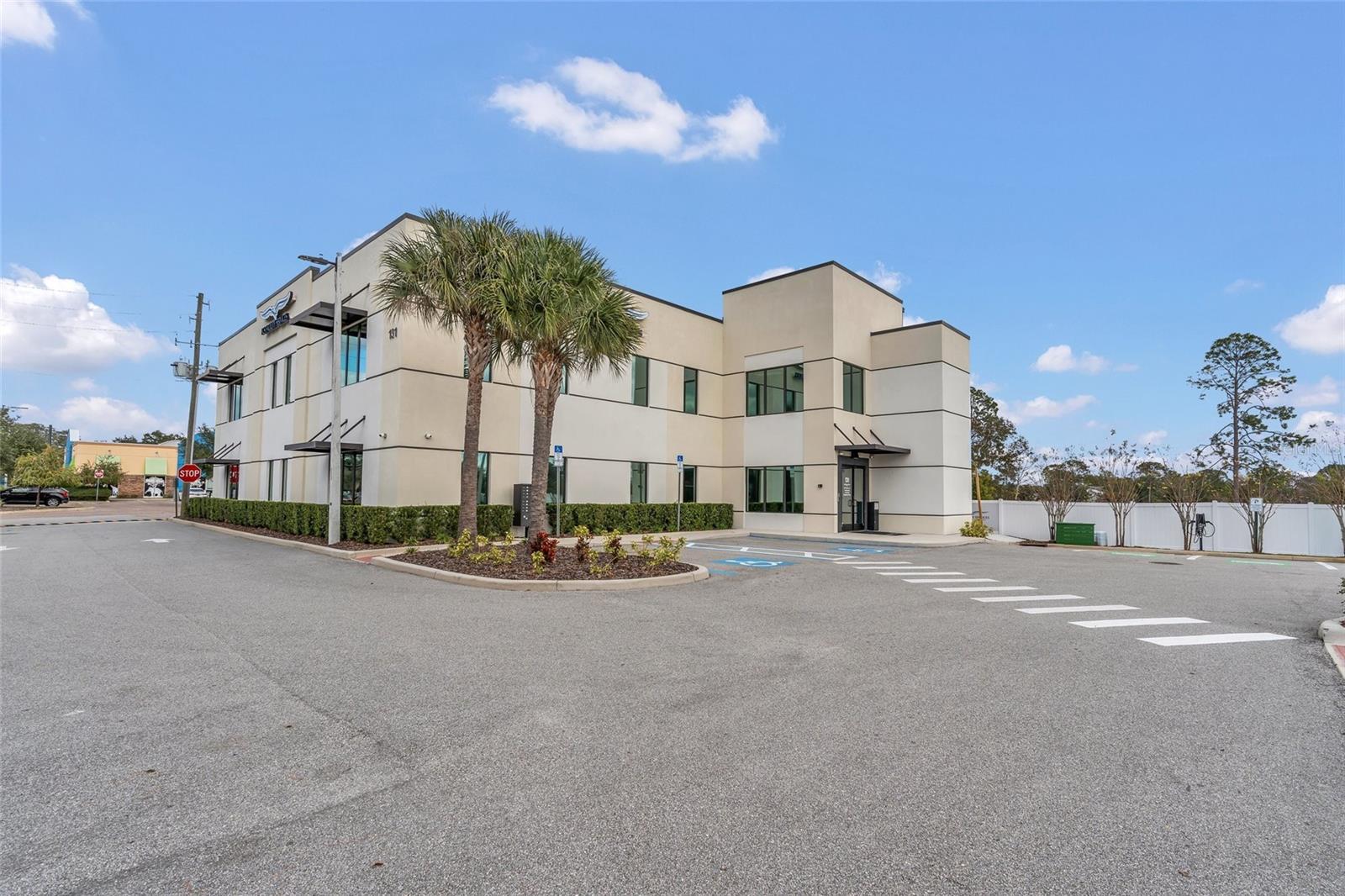 This premier office offering in Lake Mary, Florida presents a rare opportunity to acquire a high-quality office building with a fully approved outparcel for additional development. Ideally located near Downtown Lake Mary and the SunRail Station, the property combines strong visibility, walkability, and long-term growth potential.

The existing 10,592-square-foot office building sits on a 1.07-acre site and is thoughtfully designed for both owner-users and investors. The building is configured with six separately metered office suites, providing flexibility for multi-tenant occupancy or partial owner use. Interior finishes include six modern kitchenettes with quartz countertops and stainless steel appliances, multiple interior stairwells, an elevator, and a secure access control system. Additional highlights include ample parking, EV charging stations, and crown signage on two sides for enhanced branding. Second-floor offices enjoy scenic views of Lake Mary, further elevating the work environment.

Complementing the main building is a prime 0.40-acre outparcel lot with approved plans for a 5,827-square-foot office building, allowing a buyer to immediately capitalize on future development. The approved design includes two office suites (2,209 SF and 3,618 SF) and benefits from direct frontage on Country Club Road with 10,300 AADT, offering excellent exposure and accessibility.

This property represents a turnkey investment and development opportunity in one of Central Florida’s most desirable office submarkets.