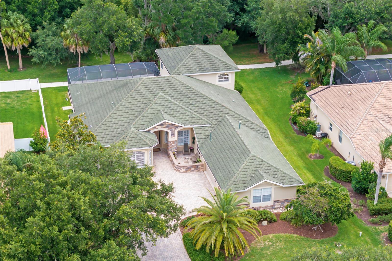 Greyhawk Landing offers one of the area's most compelling lifestyle values. Offering over 3,600 square feet of thoughtfully designed living space on an oversized preserve homesite with no front or rear neighbors, custom-built home with five-bedroom, 3.5 bathroom, den, delivers the flexibility buyers demand for multigenerational living.  Expansive preserve views, frequent wildlife sightings, and the tranquility of protected conservation land create a rare sense of privacy that is increasingly difficult to find. Inside, soaring ceilings, abundant natural light, and a flowing open floor plan create an inviting atmosphere designed for both everyday living and entertaining. At the heart of the home, the kitchen connects seamlessly to the main living areas, making it the natural gathering place for family and friends. The private owner's retreat serves as a sanctuary of its own, featuring windows on multiple sides, a comfortable sitting area,  a spa-inspired bath with a walk-in shower and garden soaking tub. A dedicated upstairs loft, fifth bedroom with full bath offers exceptional flexibility as a guest suite. Step outside to your screened pool oasis, where recent updates including a new pool pump, aerator, skimmer, and pool resurfacing provide peace of mind for years to come. Additional improvements include two newer HVAC systems, hurricane shutters, hot water heater, and an oversized three-car garage with epoxy flooring.   Residents enjoy two resort-style clubhouses,  pools with waterslide, fitness center, tennis, pickleball, basketball, soccer fields, fishing pier, and miles of scenic nature trails, all within a gated community with remarkably low HOA fees. Located minutes from Lakewood Ranch, Sarasota, Bradenton, top-rated schools, I-75, shopping, dining, and the Gulf Coast's world-renowned beaches. It's a home designed to adapt to the way you live today and grow with you tomorrow in paradise.