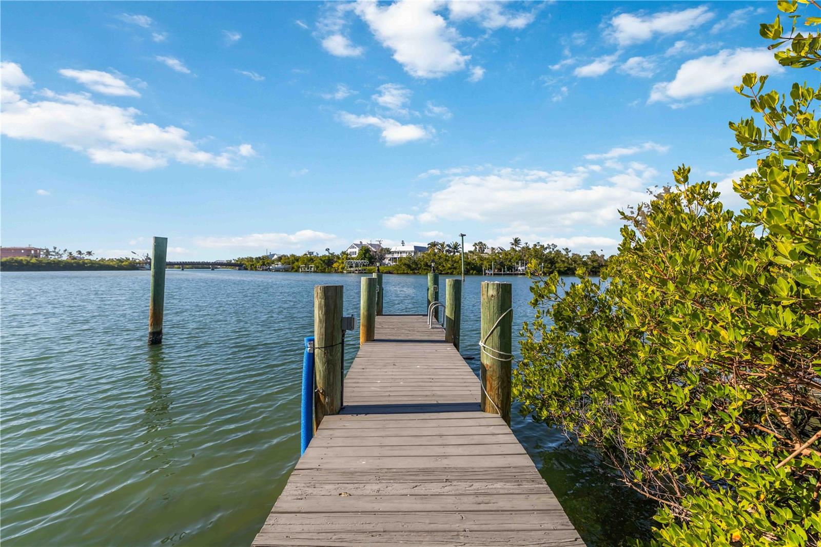LOWEST PRICED SINGLE FAMILY HOME ON ISLAND W NO BRIDGES TO GULF FROM PRIVATE DOUBLE SIDED BOAT DOCK WITH WATER AND ELECTRIC.  Experience the unmatched allure of Palm Island, one of Florida’s most secluded and luxurious coastal escapes.  Please see Realtor remarks regarding assumable mortgage offered by seller at EXTREMELY ATTRACTIVE RATE.  This seven-mile barrier island, nestled between Sarasota and Fort Myers on the Gulf Coast, is accessible only by car ferry—instantly creating an atmosphere of exclusivity and tranquility from the moment you arrive. Here, sugar-white beaches, serene harbors, winding lagoons, world-class fishing think prize Tarpon, and extraordinary shelling become the backdrop to a lifestyle defined by relaxation and natural beauty.
Set on the intracoastal waterway, this stunning home offers approximately 1,800 square feet of inviting living space with three beautifully appointed bedrooms and two baths. The dramatic loft-style primary suite features a queen bed, its own sitting area with a convertible single, and even a full bed set within an expansive walk-in closet. The additional bedrooms provide generous accommodations, including two full beds in one room and a queen in the other, ensuring comfort for family and guests alike.
The expansive great room elevates coastal living with its corner wood-burning coral fireplace, soaring vaulted ceilings, and a fully equipped kitchen boasting a gas cooktop—ideal for relaxed evenings or entertaining. Step onto the screened balcony for delightful peek-a-boo views of the canal and intracoastal, or retreat to the private third-floor terrace off the loft bedroom for a peaceful morning coffee high above the island.
The property’s deep-water, double-sided dock—with both electric and water—invites you to launch into endless boating adventures. Below the home, a beautifully pavered area creates a breezy open-air retreat complete with an outdoor shower, offering even more space to enjoy island living.
Palm Island’s charm extends beyond the home with the beloved Rum Bay Restaurant, its adjacent ice cream shop, and the island’s signature amenities including kayak, paddleboard, and golf cart rentals. The ferry runs daily, offering seamless access to your private sanctuary—just drive aboard, cross the water, and step into a world where life slows down and serenity takes center stage.
Palm Island is more than a destination; it is a truly extraordinary place to call home.