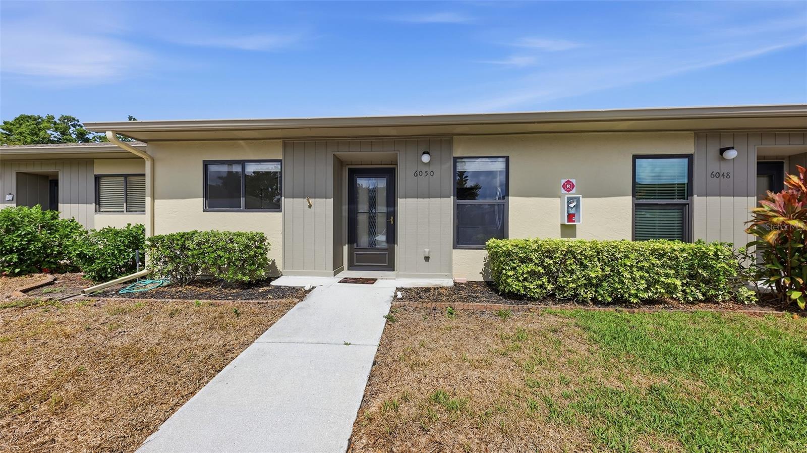 # Welcome Home to 6050 28th St W, Bradenton, FL 34207

Discover this beautifully renovated villa-style condo nestled in the desirable Huntington Woods community. This single-story gem offers 2 bedrooms, 2 bathrooms, and 1,076 square feet of thoughtfully designed living space — perfectly positioned for both homeowners and savvy investors seeking strong rental income potential.

Step inside to find a large tiled foyer leading to stunning wood-grained luxury vinyl flooring throughout the open-concept living and dining areas, crowned by a soaring vaulted ceiling that fills the space with natural light. The impressive kitchen boasts white quartz countertops, crisp white cabinetry, a stylish tile backsplash, and a generous pass-through window with breakfast bar seating — ideal for cooking and entertaining.

The smart split floor plan features spacious bedrooms, with the primary suite offering an ensuite bathroom with matching quartz countertops and a large walk-in closet. An in-unit washer and dryer, A/C replaced in 2023, and an enclosed lanai with extended patio round out this retreat.

The association handles grounds maintenance, exterior upkeep, roof, and cable — making this a true low-maintenance lifestyle. Plus, it's pet friendly!

Location is everything, and this condo delivers. You're minutes from State College of Florida, the world-renowned IMG Academy, Publix shopping, and the stunning beaches of Anna Maria Island. Sarasota Bradenton International Airport is just a short drive away, with easy US-41 access connecting you to everything the Gulf Coast offers.

Don't miss this incredible opportunity!