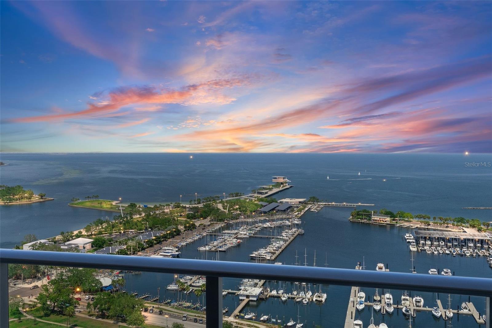 Unobstructed Water Views in a Rare Center Unit at ONE St. Petersburg Step into a realm of unrivaled luxury with this exquisite "03" center unit at ONE St. Petersburg - Step in this stunning 2-bedroom + den, 3-bathroom residence offers awe-inspiring, sky-high views that span the shimmering waters of Tampa Bay. With 1,854 square feet of meticulously designed space, the home captures panoramic vistas of Tampa Bay, the iconic St. Pete Pier, vibrant sunrises, the marina, the airport, and the glittering city skyline, offering an ever-changing canvas of beauty and tranquility. Upon entering, you are greeted by a grand open-concept living area with soaring 10-foot ceilings, full-height windows, and sliders that bathe the space in natural light. The upgraded tile flooring throughout complements the sleek, modern aesthetic. Electric blinds and designer lighting enhance the ambiance in the dining room, owner’s suite, guest suite, and den, adding both functionality and elegance. A highlight of this exceptional home is the expansive 40-foot-wide private terrace, seamlessly integrating indoor and outdoor living. Perfect for entertaining or enjoying peaceful moments overlooking the shimmering waters, this terrace is a rare find in downtown St. Petersburg. The ONE St. Petersburg building itself sets a new standard for luxury living, offering an impressive array of amenities. Residents enjoy concierge services, an activities director, and access to a formal social room, game room, and club room. The 40,000-square-foot amenities deck includes a 75-foot lap pool, cabanas, a spa, lush landscaping, fire pits, ample seating, and an outdoor kitchen ideal for hosting gatherings. Fitness enthusiasts will appreciate the state-of-the-art fitness center and yoga studio. Located in the vibrant heart of downtown St. Petersburg, ONE St. Petersburg offers unparalleled convenience. Enjoy easy access to over 40 restaurants, upscale shopping boutiques, museums, theaters, galleries, and the scenic waterfront. Whether you crave cultural experiences, fine dining, or leisurely walks along the bay, everything is just steps away from your doorstep. Experience the epitome of modern luxury living in downtown St. Petersburg with this stunning condo at ONE St. Petersburg. Schedule your private tour today and immerse yourself in the ultimate waterfront lifestyle.