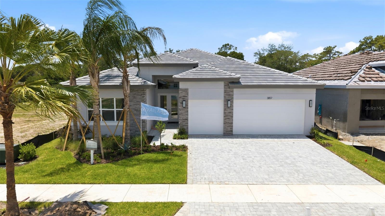 New construction is now ready and priced to sell! Originally $889,719, this home is now listed at an incredible price of $846,900, offering immediate savings of $42,819. This property comes with the added value of included furniture as shown in the photos.
Experience the beauty of Florida sunrises and sunsets from this stunning East Facing property. The property presentation is pristine, and every detail has been perfectly captured. This property features a gorgeous, oversized flex space offering endless possibilities for customization and use. The perfect kitchen awaits you featuring stunning cabinetry, high-end appliances, an oversized island, a stylish backsplash, gas cooktop, a chimney-style range hood, soft touch drawers and ample counter space, making it a true centerpiece for both cooking and entertaining. The Primary Ensuite features an expansive layout with stylish finishes and ample space. Cozy living area featuring stackable sliding glass doors that seamlessly connect the indoor and outdoor spaces. This beautifully crafted home is designed to make entertaining delightful. Enjoy an extended covered patio, screen enclosure, coffered ceilings, recessed & pendant lights, elongated chair-height toilets, upgraded tiles, pre-plumbed for a summer kitchen, laundry sink and water softener. It also includes a tankless gas water heater, keyless entry, a monitored security system, a glass entry door, an extended three-car garage and much more. The community features maintenance-free lawn care and is characterized by gorgeous tile roofs and elegant paver driveways, creating a cohesive and upscale neighborhood aesthetic. The photos reflect the actual home, which is pristinely presented and move-in ready, all featured furniture is included in the purchase. At Valencia Ridge you're just minutes away from fine dining, entertainment, multiple malls and shopping choices. Enjoy an onsite community restaurant, tennis, pickleball, community events, a lifestyle coordinator, swimming pools and much more. Valencia Ridge is an active adult community you're sure to love!