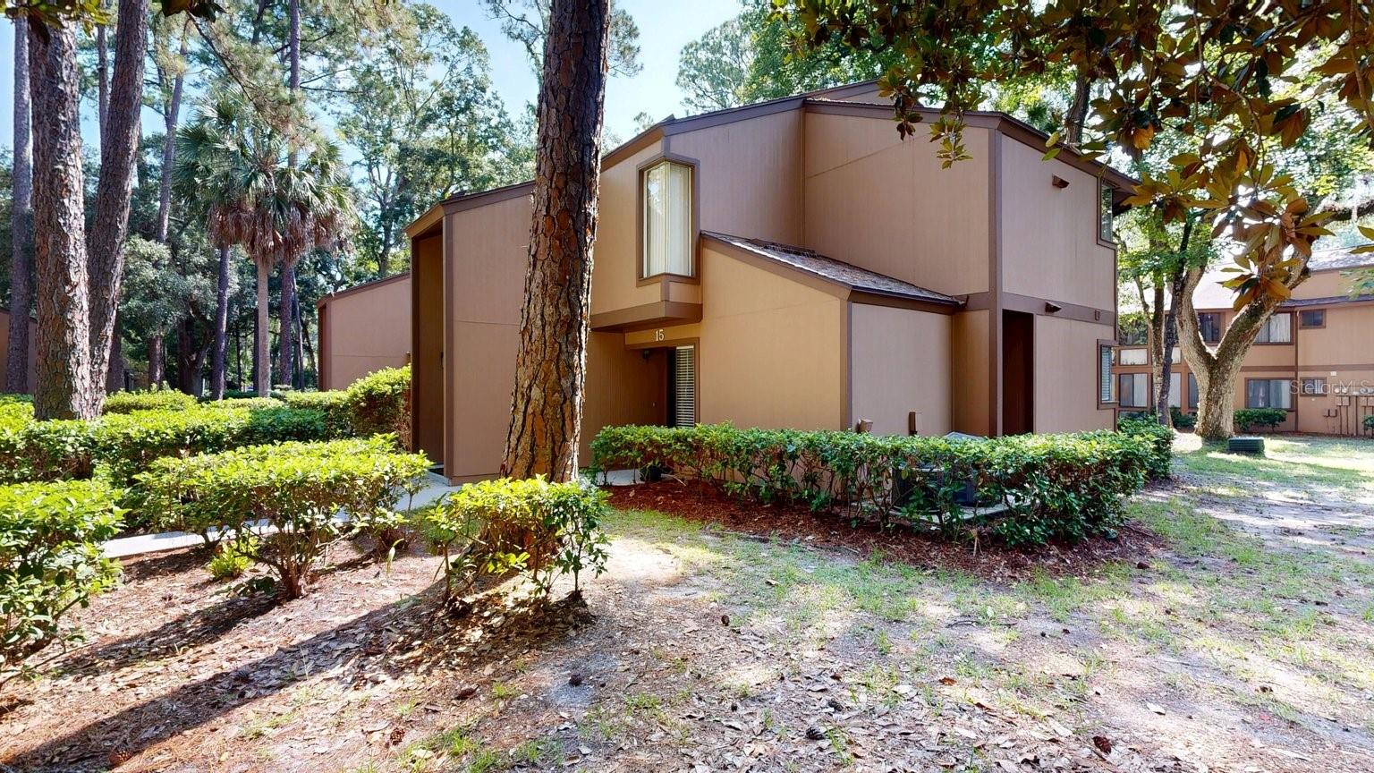 Updated 2-bedroom, 2-bath condo in The Fairways at Palm Coast, a wooded community in Flagler County with tennis court and mature landscaping. Ground-floor unit, single-story building, approximately 1,150 sq ft  public records. Kitchen features granite countertops,  cabinetry, and stainless steel appliances including French door refrigerator and stacked washer/dryer. Luxury vinyl plank flooring throughout main living areas, tray ceilings, and ceiling fans in multiple rooms. Screened and covered rear porch. Flexible bonus room currently set up as a home office, plus a second bonus room outfitted as a home gym. Primary bath with walk-in shower and granite vanity; second full bath with tub/shower combo. Central air conditioning, slab foundation, shingle roof. Common area parking with 2 assigned spaces. Located in Palm Coast, FL 32137, close to Palm Coast Pkwy NE and Palm Harbor Pkwy. Community offers tennis court and wooded, park-like grounds. Buyer to verify all room dimensions, square footage, and HOA information.