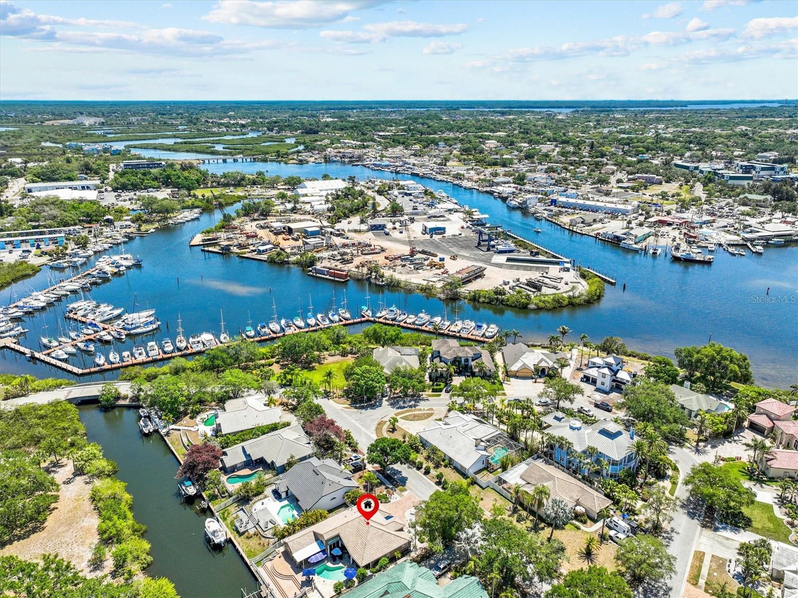 BOATER’S PARADISE – Your Dream Dock & No Flooding!
Imagine waking up to and stepping onto your private dock, and casting your line into waters teeming with fish – all before your morning coffee. This is more than a home. This is your ultimate fishing and boating escape, where every day feels like an adventure on the water.

Perfectly positioned with direct Gulf access in just 8 minutes and NO bridges to navigate, this rare gem delivers everything serious boaters and anglers crave. Enjoy your own private dock with a powerful 12,000 lb Hi-Tide boat lift ready for your boat. This is an almost impossible combination: a true deep-water boat dock with zero flooding history, even through the 2024 hurricanes – priceless for peace of mind.

The fully fenced yard and lush tropical vegetation across the canal create a private sanctuary that feels worlds away from everything. No typical canal “fishbowl” exposure here – just peaceful privacy and breathtaking waterfront views. Watch dolphins and manatees glide gracefully past your dock while you reel in the day’s catch. Pure magic.

Step outside and you’re greeted by a sparkling remodeled heated pool surrounded by elegant travertine decking. Fire up the large natural gas grill in your stunning outdoor kitchen (complete with refrigerator), pour your favorite drink, and gather friends and family around the striking two-way fireplace. As the sun dips low, painting the sky in fiery colors, you’ll enjoy spectacular private sunset views over the water — the perfect backdrop for unforgettable evenings.

Inside, the home feels equally extraordinary. Soaring ceilings and walls of glass with massive 8-foot sliders flood the space with light and seamlessly blend indoor comfort with outdoor living. Beautiful plantation shutters add elegance while framing those inspiring waterfront views.

This home has been meticulously maintained and recently upgraded for worry-free living: Brand new tile roof with double underlayment (approx. $60,000 in 2024), top-of-the-line HVAC system (approx. $20,000 in 2026), tankless water heater (2025), fresh interior and exterior paint, most windows replaced in 2022 with hurricane-impact glass + full storm protection. 

Located in Flood Zone X, flood insurance is not required - yet the current owner’s voluntary policy (just $1,266 per year) can transfer to you. This property has never experienced water intrusion through any storms. That kind of proven resilience is pure gold for waterfront living.

Tucked into a tranquil island community with only 19 waterfront homes (and just 10 allowed boat lifts), this feels exclusive and serene – yet you’re still minutes from the Pinellas Trail, world-famous Tarpon Springs Sponge Docks, Fred Howard Park, and Sunset Beach.

Dock. Boat lift. No flood history. This is the rarest of finds – and it’s waiting for you.
Your next chapter starts here – and it’s going to be spectacular. Are you ready to live the fisherman’s dream?