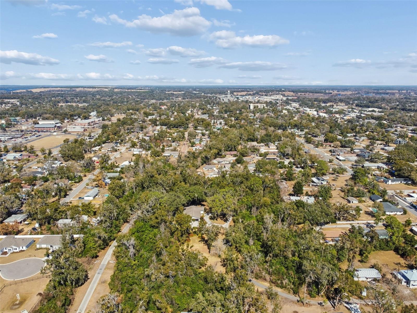Rarely does a property provides this kind of versatility and long-term upside. This unique 5-acre property includes three separate parcel IDs, creating an exceptional opportunity for builders, investors, or buyers seeking space with future flexibility, Bordering the scenic Hardy Trail and just minutes from historic downtown Dade City’s charming shops, restaurants, and conveniences, this property delivers the perfect balance of privacy and accessibility. The setting is peaceful, wooded, and increasingly hard to find. The existing residence provides immediate value and options. Live comfortably in the home while developing the additional parcels, create a multigenerational compound, generate rental income, or build and sell new custom homes. The choice is yours. Call today for appointment!  Lots and Home being sold as a package.