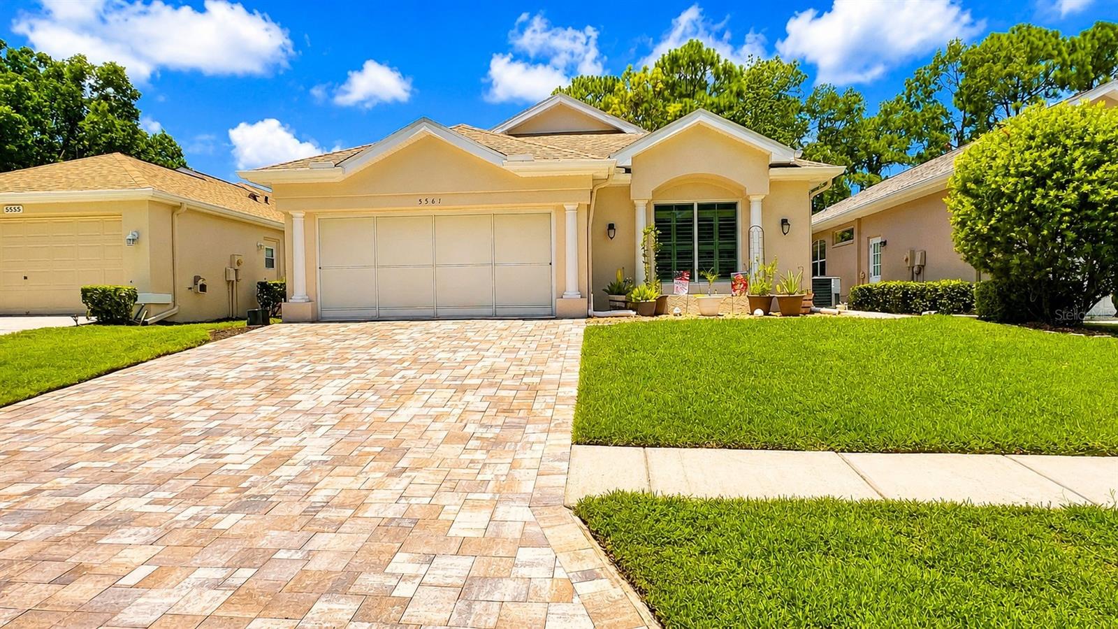 Beautiful solar-powered, energy-efficient 3-bedroom, 2-bath villa located in the luxury Silverthorn Golf Course gated community in the heart of Spring Hill, Florida, just minutes from the Suncoast Parkway. This move-in-ready home features a spacious open floor plan with a formal dining room and an oversized eat-in kitchen centered around a massive island perfect for family gatherings. The gourmet kitchen includes an induction cooktop, double ovens, a wine rack, a window seat, a butler's pantry with an electrical outlet, and a smart refrigerator with remote app control and a Hideaway Door for water/ice dispenser. The primary suite offers dual walk-in closets with barn doors, private sliding glass doors to the Florida room, and a luxurious bath with a zero-threshold roll-in shower and separate water closet. The front bedroom includes custom closet shelving. The living room features full-width disappearing sliding glass doors that open to the screened Florida room with a 2-person hot tub spa included, overlooking the golf course where you can enjoy peaceful morning sunrises. Additional upgrades include a 2024 solar energy system, 2024 A/C, 2019 roof, 2023 front window replaced and front doors, decorative front entry window, and a 2-car garage with overhead drop-down storage. Numerous extras are included, with additional items available through negotiation. Enjoy maintenance-free luxury living with golf course views in one of Spring Hill's premier communities. Call today to schedule your private tour.