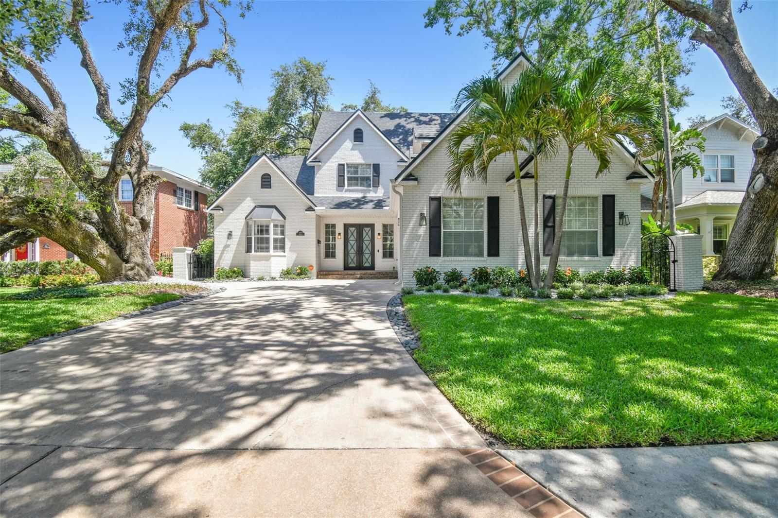 Step into this beautifully renovated 4-bedroom, 3.5-bath home in the prestigious Parkland Estates neighborhood. This two-story residence boasts 3,573 square feet of thoughtfully designed living space, seamlessly blending classic charm with modern upgrades.
Upon entry, you’re greeted by soaring vaulted ceilings and stunning hardwood floors that flow throughout the home. The great room, complete with a wood-burning fireplace, opens to a designer gourmet kitchen, remodeled in 2018. This culinary space is a chef’s dream, featuring a Viking six-burner gas range, a second Viking oven, a built-in wine fridge, a large island, and custom cabinetry with storage and seating. The downstairs primary suite, renovated in 2020, includes a private entrance to the backyard, high ceilings, an oversized walk-in closet, a spa-like bathroom with marble countertops, a large soaking tub, and a custom glass-enclosed walk-in shower. An additional guest bedroom downstairs with an en suite bath, a stylish office with custom built-ins, and an oversized laundry room round out the first floor. Upstairs, a versatile loft space offers the perfect setup for a home gym or study area. Two spacious bedrooms feature custom-built closets and share a newly remodeled Jack-and-Jill bathroom.
Outdoor living is equally impressive with a deep lot featuring a heated pool and spa, a sun shelf, and sophisticated lighting. Trex decking, lush mature oaks, plantation shutters, turfed yard and meticulous hardscaping enhance the private oasis. A two-car garage, a tankless water heater, and recent roof and AC updates (2025, 2024) ensure modern efficiency. Located minutes from premier shopping, dining, Tampa International Airport, and steps from Palma Ceia Golf Course, this home truly has it all. Don’t miss the opportunity to make this exquisite property yours!