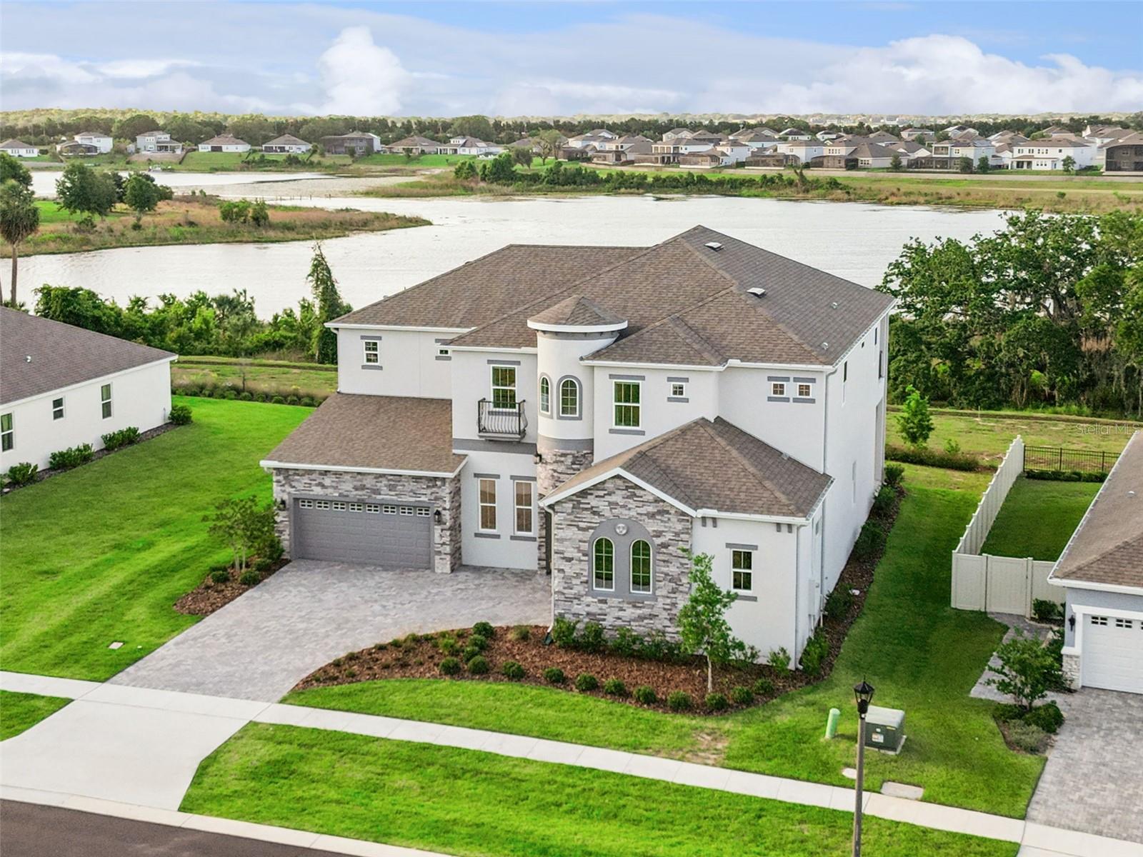 Sunset Lake Views | Luxury Upgrades | Move in Ready | Positioned on a Cul-de-Sac homesite with unobstructed views of Lake Avalon, this six-bedroom residence offers a functional two-level layout. Built in 2024 and enhanced with extensive owner improvements completed after purchase. The main floor supports single-level living with a primary suite, guest bedroom with en-suite bathroom, study, and an extensively upgraded kitchen and butler’s pantry featuring an oversized  10’ x 7’ island, quartz countertops, stacked cabinetry, dual Bosch dishwashers, Thermador microwave, and Samsung appliances. New luxury vinyl flooring extends throughout the first level, complemented by 12-foot ceilings.

The primary suite features tray ceilings, automatic blinds, a large walk-in closet, and a remodeled bath with floor to ceiling tile and seamless glass shower. Upstairs includes a 33x22 loft, media room, four additional bedrooms, climate-controlled storage, and a balcony with elevated lake views.

Other recent updates include interior paint, lighting, and gutters. Community amenities include a recreation area and walking trails, with convenient access to the 429, downtown Orlando, Walt Disney World, and top-rated schools.