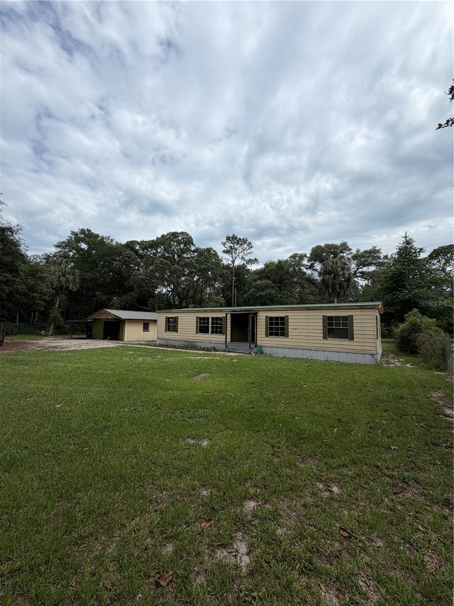 INVESTOR SPECIAL! Oversized .72 acre lot goes road to road and nice sized home. Needs full renovation but there is good base to start. Mobile home is 1976 with 3 bedrooms 2 bathrooms and 1344 living square feet with metal roof and large rear porch. There is a 20x20 concrete building with 110 power and attached carport(currently being used as chicken/rabbit pen. Two wells; one 4" well(150') in 2024 and also back up 2" well. HVAC is approx. 4 years old. Located 10 minutes from downtown Fort McCoy with a grocery store, doctor's office, pharmacy, hardware, gas station, pizza, and more. Short drive to Silver Springs which includes Walmart, Lowes, Bealls, Outback and many more of your favorite shopping spots and restaurants. Ocala is only another 10 minutes from Silver Springs with vibrant night life and lots of entertainment options and restaurants. Gainesville(Home of Florida Gators) is only 50 minutes to downtown. If you’re a fisherman, or hunter or simply love hiking, canoeing or kayaking you are in luck! Minutes to Ocklawaha River, Ocala National Forest, and many natural springs(Salt Springs, Silver Glen Springs, Juniper Springs), horseback and walking trails, and off-road vehicle trails await your explorations. One-of-a-kind property and location! Ready for new owners!