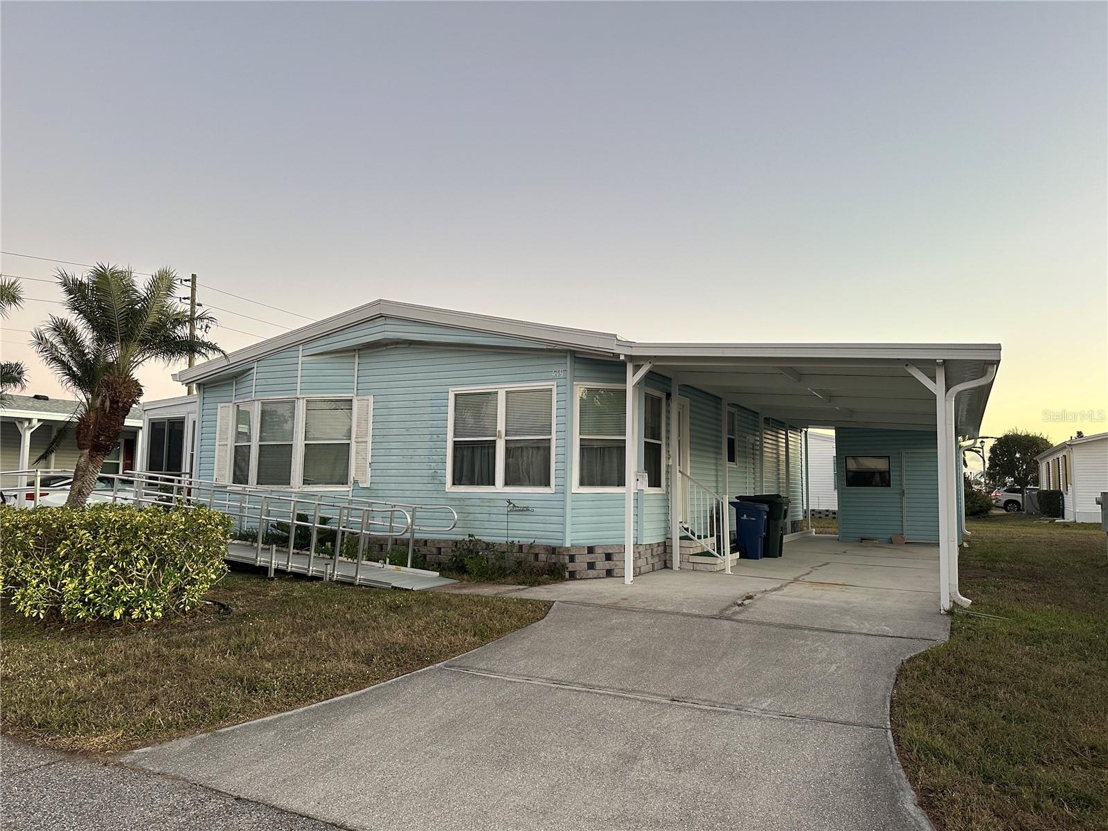 Located in the award-winning 55+ community of Harbor Isles in North Port, this double-wide manufactured home offers a great opportunity to create your own Florida retreat. The home is functional and well laid out, featuring generous living spaces, but is ready for cosmetic updates and a little TLC—perfect for buyers who want to add their own finishing touches and build instant equity. A new roof installed in 2025 provides peace of mind and adds significant value. Enjoy the Harbor Isles lifestyle with resort-style amenities including a clubhouse, community pools, marina, fitness center, and an active social calendar. Conveniently located near shopping, dining, medical facilities, and Gulf beaches, this home is an excellent value in a sought-after community.