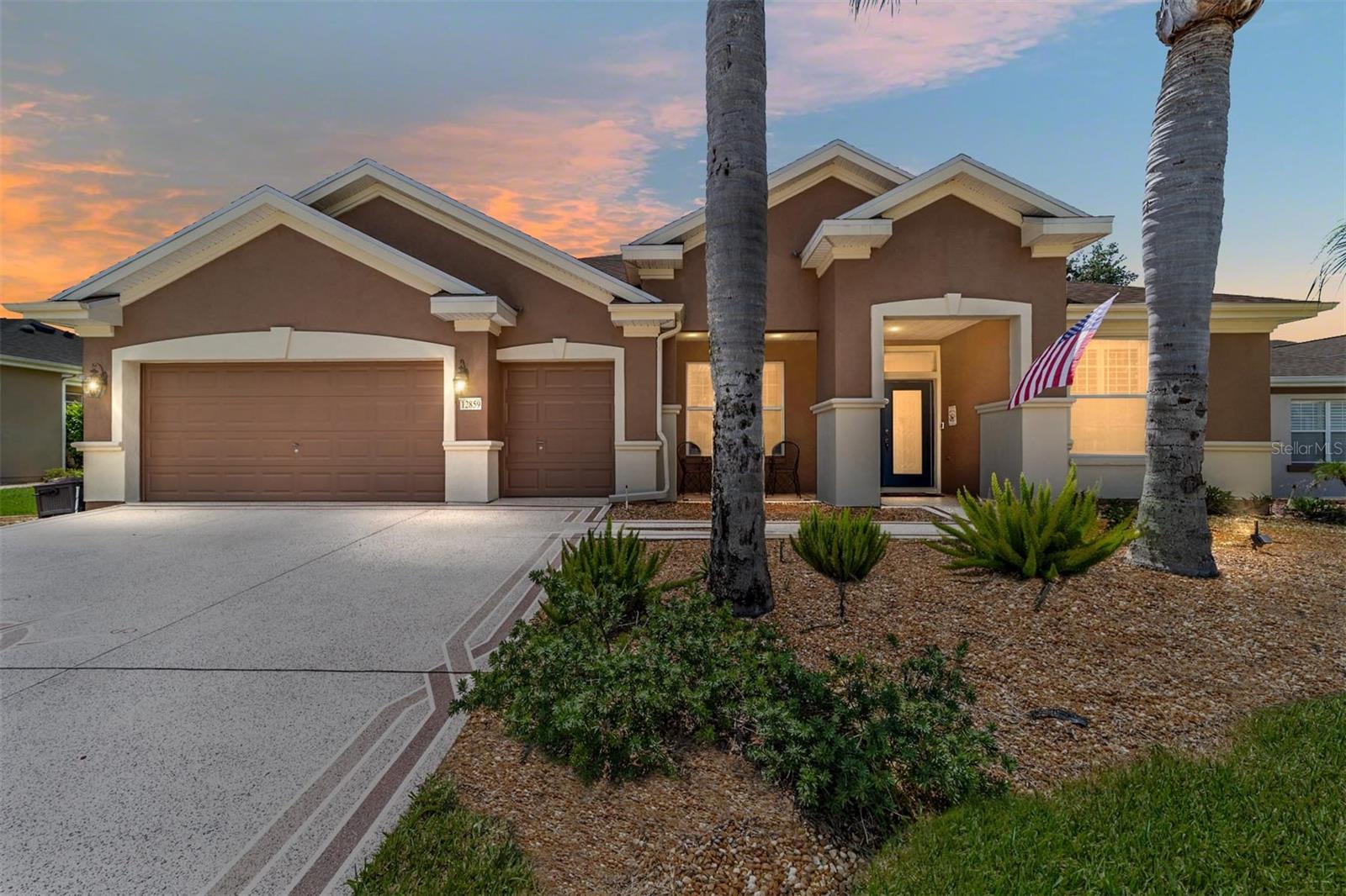 Move-in ready and beautifully updated, The Lexington offers golf course living on a quiet cul-de-sac with a new pool. This split-bedroom home features 3 bedrooms plus a library, 2.5 bathrooms, and an enclosed lanai under heat and air. Highlights include a designer driveway and walkway, covered front porch, front beveled glass double entry doors, engineered hardwood floors, plantation shutters, remodeled kitchen, library/office with built-ins, a golf cart garage, and a stunning pool installed in 2019 with a sun shelf and birdcage. Additional updates include a kitchen reverse osmosis system, water softener, newer kitchen appliances, new ceiling fans, sculpted bedroom carpeting, professional landscaping with hacienda walls and more. Major updates include Roof 2022, HVAC 2019, Water Heater 2025, and Water Softener 2020.  Located on the eighth hole of the Memorial Course in the beautiful tree-canopied community of Del Webb Spruce Creek Golf and Country Club, where the amenities are top notch and you will find four (4) 9-hole golf courses. Conveniently located just north of The Villages and just south of Ocala, puts you right in the lap of fine restaurants, wonderful shopping and great entertainment. This 55+ community cannot be beat! Call today to schedule your private viewing.