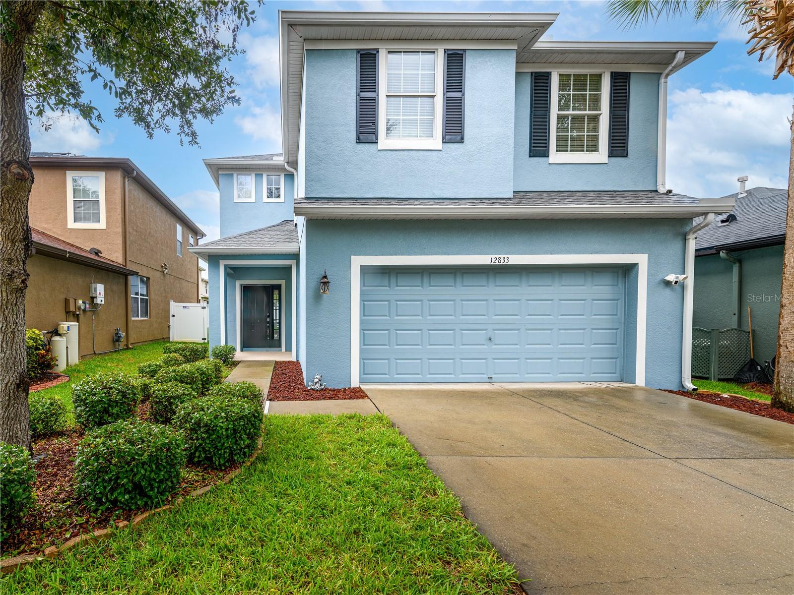 Welcome to this beautifully maintained 4-bedroom, 2.5-bath home in the desirable Avelar Creek North community. Featuring a NEW (June 2026) roof and numerous recent updates, this move-in-ready home offers the perfect blend of style, comfort, and convenience. Step inside to an inviting open living area with soaring ceilings and an abundance of natural light. The refreshed kitchen showcases newly painted cabinetry that brightens the entire space while overlooking the family and dining rooms, creating the perfect layout for everyday living and effortless entertaining. Open the pocket sliding glass doors that disappear behind the wall, seamlessly extending your living space onto the screened-in porch. Whether you're hosting friends or enjoying a quiet evening, you'll appreciate the peaceful water views and added privacy this inviting outdoor space provides. All four bedrooms are conveniently located upstairs. The spacious primary suite is privately situated on one side of the home and features a generous sitting area that can easily serve as a home office, reading nook, or workout space. The suite also includes a large walk-in closet and an ensuite bathroom with updated granite countertops and freshly painted cabinetry. The remaining three bedrooms are located on the opposite side of the home and share a beautifully updated full bathroom with matching granite countertops. Additional improvements include fresh exterior paint and newly installed gutters, (2024) enhancing both curb appeal and functionality. Residents of Avelar Creek North enjoy access to a clubhouse, community pool, and playground. Conveniently located just off US-301, you'll have easy access to shopping, dining, healthcare, and major commuter routes. Located in a highly rated school district, this home offers the ideal combination of location, functionality, and modern updates. Don't miss your opportunity to make this beautiful home yours!