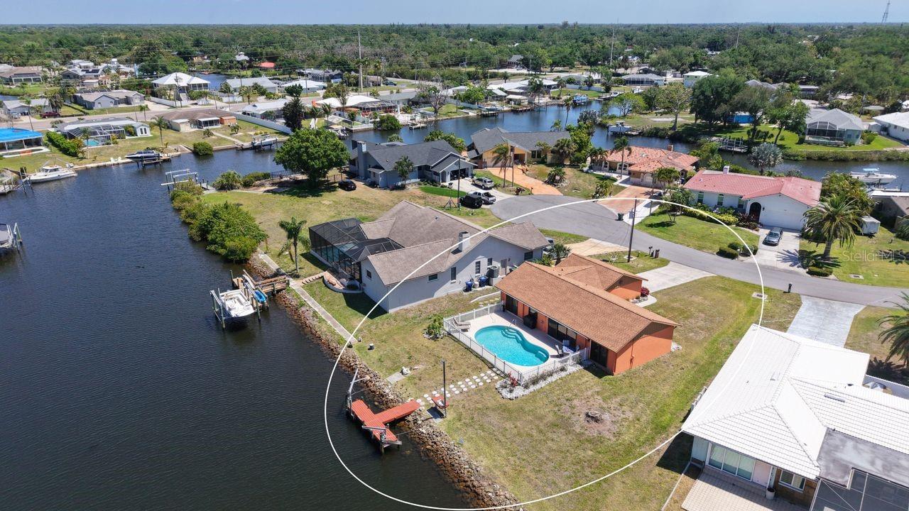 Tucked at the end of a QUIET CUL-DE-SAC, where traffic fades and the only real noise is the water, this WATERFRONT HOME WITH GULF ACCESS delivers the kind of setting people come to Florida hoping to find. Step inside and it immediately feels easy… FRESHLY PAINTED, LIGHT-FILLED, and METICULOUSLY KEPT, with a layout that flows naturally from everyday living to relaxed evenings at home. The kitchen is both functional and inviting with GRANITE COUNTERTOPS and a TILE BACKSPLASH, while both bathrooms have been FULLY REMODELED, giving the home a clean, updated feel where the work has already been done. Major upgrades including a NEW ROOF (JUNE 2024 WITH TRANSFERABLE WARRANTY), NEW GARAGE DOOR, NEW HVAC 2026, NEW SUBMERSIBLE WELL PUMP 2026, POOL HEATER, NEW SEPTIC TANK, REFRIGERATOR, WASHER AND DRYER mean less to worry about and more time to enjoy this TURN-KEY home. Out back is where this home separates itself. The HEATED POOL overlooks the water with OPEN VIEWS THAT STRETCH OUT AND HOLD YOUR ATTENTION, whether it’s morning coffee, an afternoon swim, or winding down as the sky changes at sunset. With DIRECT GULF ACCESS, the water isn’t just a view… it’s part of your day. Boat out, explore, or simply enjoy the stillness right from your own backyard. With NO HOA, you have the freedom to truly make it your own, without restrictions getting in the way of how you want to live. When you’re ready to head out, you’re just minutes from the shoreline… Nokomis Beach and Venice Beach are roughly 11–15 minutes away, making it easy to go from home to sand, water, and sunset whenever you feel like it. Local restaurants, waterfront spots, and everyday conveniences are all close enough to keep life simple without giving up the calm this location offers. This is the kind of place where the pace slows down, the views stay with you, and the FLORIDA WATERFRONT LIFESTYLE actually feels real… not just something you visit.