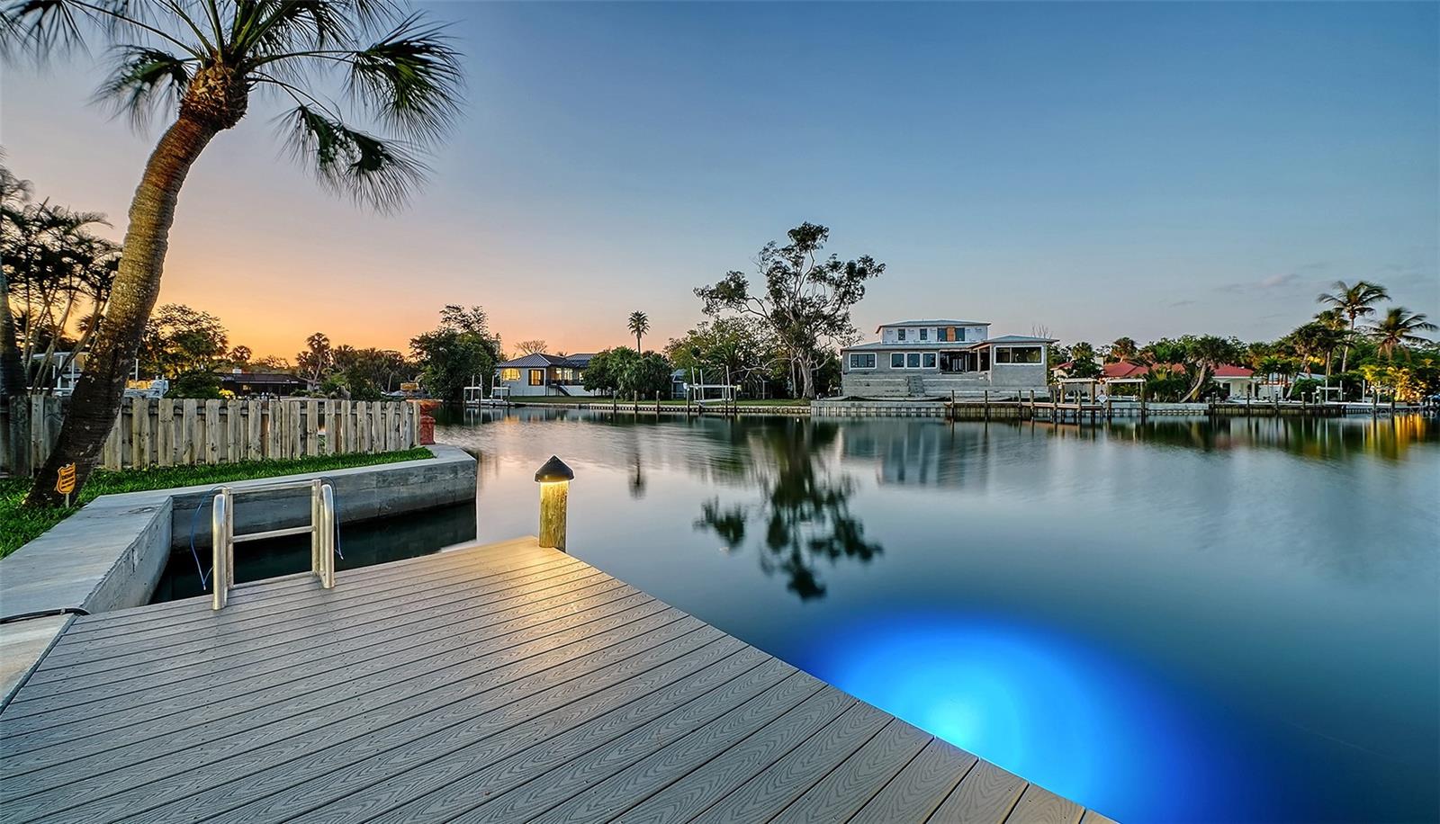 Stroll to the Village.  Walk to the Beach. Cruise to the Gulf of Mexico.  Elegant Siesta Key Waterfront Living. Don’t just move. Arrive! Enter into your residence, and the world falls away. Picture-perfect postcard views from nearly every room await to welcome you home. Nestled on an unrivaled point at the intersection of the Grand Canal’s most impressive waterways, this newly renovated, rare find offers you the complete package. Luxury finishes, high-tech resilience, and the quintessential Siesta Key lifestyle are prepared for you to move in ready. 
A brief stroll from the vibrant energy of Siesta Key Village and the quartz sands of Siesta Beach. With an astounding approximately 240 feet of private seawall and offering long-range canal views creating a lagoon-like setting, this opportunity simply cannot be replicated. 
While offering crisp, clean lines of modern contemporary style, the infrastructure is strictly 2026-ready. This unique residence provides both luxurious aesthetic appeals, featuring a fully updated chef’s kitchen and designer baths, and "invisible luxury". The peace of mind that comes from the resilience of a durable metal roof, new seawall, and all-new high-velocity hurricane windows and doors, new flooring, wood burning  fireplace, and new electrical, plumbing, as well as new three-zone HVAC and mechanical systems, has been thoughtfully provided. And, for your peace of mind, professional night vision high-tech security cameras and systems were installed in 2026. 
The preferred split plan offers three additional bedrooms, including a private guest suite with its own separate entrance and ensuite bath. 
Life at 339 Treasure Boat Way centers around the water. Venture out onto the paved, open-air pool deck to find a 2026 freshly re-finished Aqualink-controlled, saltwater, heated pool and spa with LED lighting.  Enjoy gentle, golden morning sun and cool, shaded afternoons—perfect for entertaining and alfresco dining. 
An oversized detached two-car air-conditioned garage, fenced yard for pets, and ample guest parking.