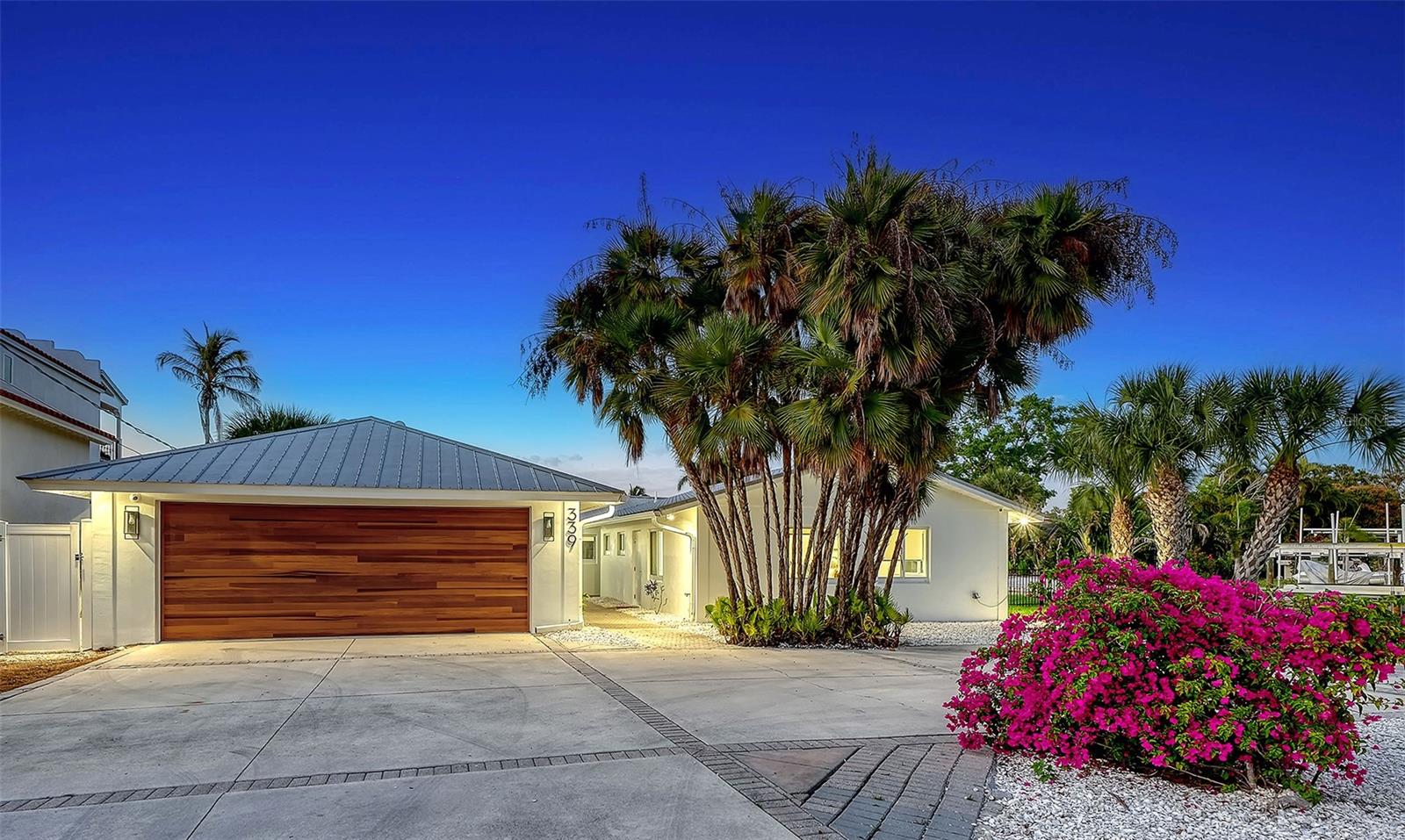 Elegant Siesta Key Waterfront Living. Don’t just move. Arrive! Enter into your residence, and the world falls away. Picture-perfect postcard views from nearly every room await to welcome you home. Nestled on an unrivaled point at the intersection of the Grand Canal’s most impressive waterways, this newly renovated, rare find offers you the complete package. Luxury finishes, high-tech resilience, and the quintessential Siesta Key lifestyle are prepared for you to move in ready. 
A brief stroll from the vibrant energy of Siesta Key Village and the quartz sands of Siesta Beach. With an astounding approximately 240 feet of private seawall and offering long-range canal views creating a lagoon-like setting, this opportunity simply cannot be replicated. 
While offering crisp, clean lines of modern contemporary style, the infrastructure is strictly 2026-ready. This unique residence provides both luxurious aesthetic appeals, featuring a fully updated chef’s kitchen and designer baths, and "invisible luxury". The peace of mind that comes from the resilience of a durable metal roof, new seawall, and all-new high-velocity hurricane windows and doors, new flooring, wood burning  fireplace, and new electrical, plumbing, as well as new three-zone HVAC and mechanical systems, has been thoughtfully provided. And, for your peace of mind, professional night vision high-tech security cameras and systems were installed in 2026. 
The preferred split plan offers three additional bedrooms, including a private guest suite with its own separate entrance and ensuite bath. 
Life at 339 Treasure Boat Way centers around the water. Venture out onto the paved, open-air pool deck to find a 2026 freshly re-finished Aqualink-controlled, saltwater, heated pool and spa with LED lighting.  Enjoy gentle, golden morning sun and cool, shaded afternoons—perfect for entertaining and alfresco dining. 
An oversized detached two-car air-conditioned garage, fenced yard for pets, and ample guest parking.