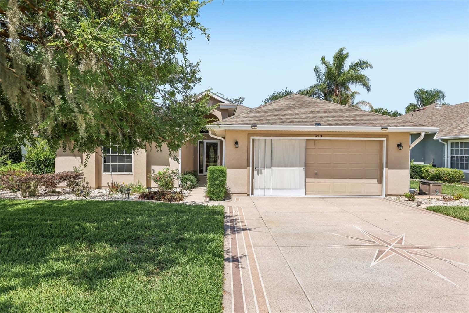 Located in desirable 55+ Baytree, this beautifully maintained 3-bedroom, 2-bath home offers the perfect blend of comfort, style, and low-maintenance Central Florida living. Tucked away toward the back of the community on a quiet street, the home enjoys a peaceful setting with a birdcage lanai overlooking tranquil greenspace, the ideal place to sip your morning coffee, enjoy evening breezes, or simply relax and unwind surrounded by nature. Inside, soaring cathedral ceilings create an open and airy feel, while the updated kitchen serves as the heart of the home with granite countertops, abundant cabinetry, center island with pendant lighting, and a sunny breakfast nook perfect for casual dining. The spacious primary suite offers a private retreat with an ensuite bath featuring double vanities and generous storage. Two additional guest bedrooms share a beautifully remodeled bathroom with a walk-in tile shower, glass door enclosure, and updated granite vanity. Life in Baytree means enjoying an active 55+ lifestyle with HOA-covered lawn maintenance, a clubhouse with pool and fitness center, plus a social hall hosting monthly dinners and community activities. Conveniently located near the waterfront dining, festivals, and entertainment of downtown Tavares, this home is also within an hour of Orlando International Airport, world-famous theme parks, and Florida beaches, making it perfect for both full-time residents and seasonal living.