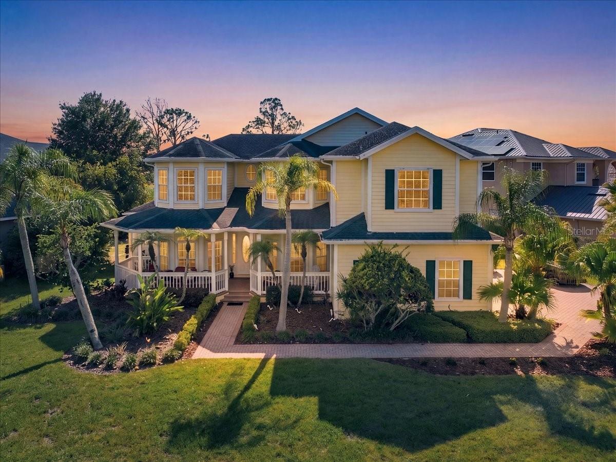 Experience ultimate waterfront luxury in the highly sought after, 24-hour guard-gated community of Cory Lake Isles. Perfectly positioned on an expansive, pie-shaped lot at the premier vantage point of a 165-acre ski lake, this Key West-inspired estate seamlessly blends resort-style living with everyday functionality.

The main level welcomes you with timeless, rustic hardwood flooring leading into a light-filled open layout. A chef-inspired kitchen features custom beadboard cabinetry with pull-out storage, premium granite countertops, and stainless steel appliances—all framed by panoramic water views. The palatial primary suite serves as a private sanctuary, boasting a massive sitting area, a private sunset-view balcony, and a spa-like travertine marble bathroom complete with a dual-head walk-in shower with independent temperature controls.

Designed for multi-generational living and entertaining, the floor plan includes four spacious bedrooms plus a massive upstairs bonus/theater room. Outside, your private oasis awaits: a custom 33’ x 17’ open-air pool with a dedicated sun-shelf, a heated Jacuzzi, and an expansive yard secured by an unobstructed aluminum fence. Enjoy premier lakefront access from your private boat dock, perfect for jet skis, boating, or fishing.

Upgrades & Features:
3-car garage with soaring 11 ft ceilings (ideal for extra storage)
Wrap-around front porch & sweeping lakeside balconies
2026 dock, seawall
Elite community amenities: Brand-new resort pool, clubhouse, tennis, basketball, and ball hockey courts.