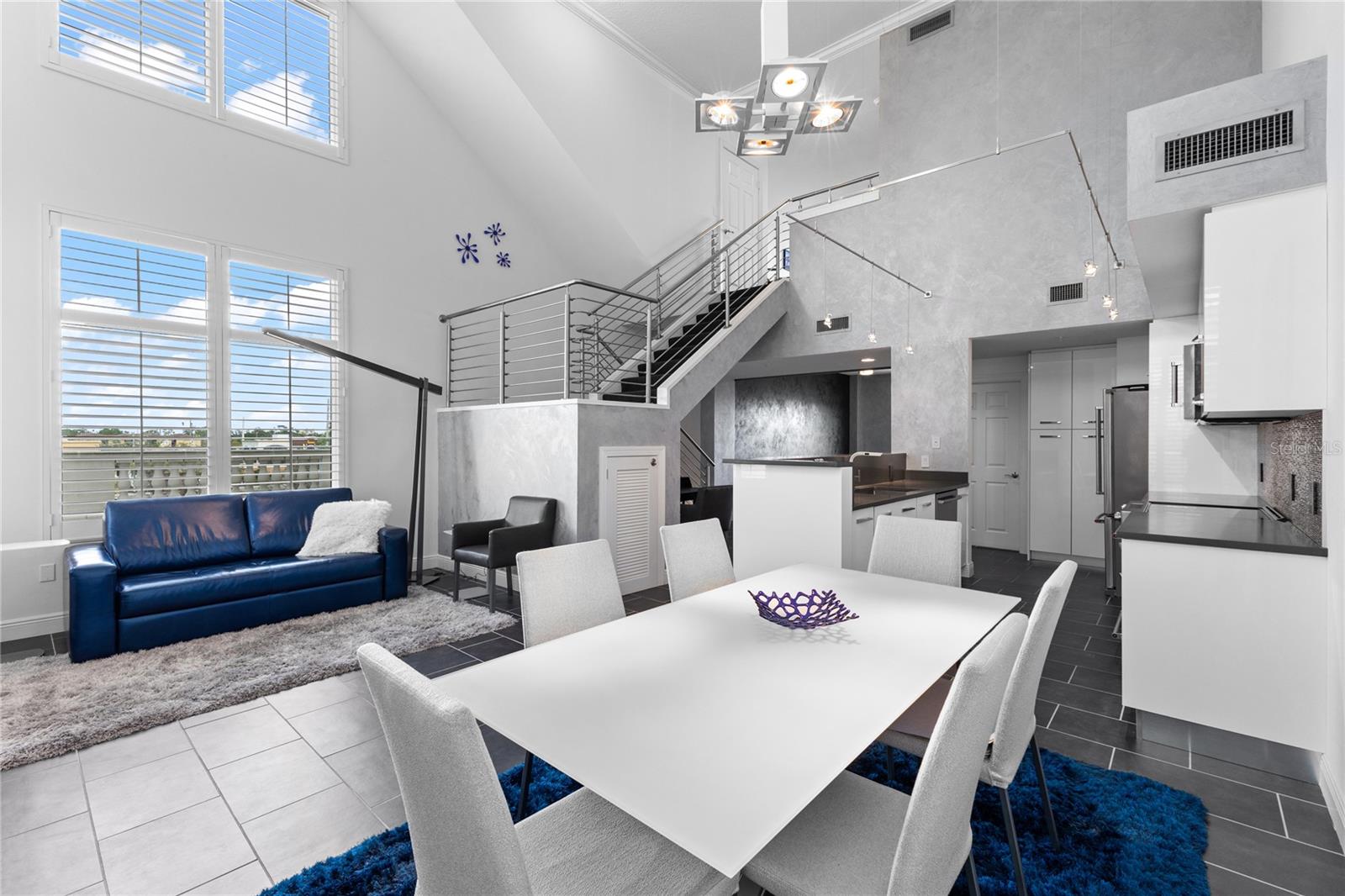 AMAZING VALUE: Unit was appraised at $850,000.  Welcome to an exciting blend of privacy, space and style in this unique multilevel end-unit townhome with your own private entrance, set within the coveted Alinari at Rosemary Place in downtown Sarasota. Enjoy 1,734 sq. ft. of remodeled interior living space & your very own private 942 sq. ft. Rooftop Deck with sweeping views of Sarasota Bay, Sarasota city skyline, resort-style pool & spa deck, & unforgettable sunsets. 1 of only 6, private townhomes located just off the pool—& the only one currently available—this residence is truly a rare offering. Upon entering at your very own private entrance, cross the threshold & enjoy soaring 18-foot ceilings showcasing ample windows that create an expansive, light-filled interior that seamlessly blends w/the outdoor scenery with high-end finishes, including custom Venetian plaster walls, designer lighting, custom plantation shutters & freshly painted interior. The kitchen is well-appointed w/quartz countertops, large bar counter, stainless steel appliances, custom designer soft close cabinetry with ample storage space & an oversized pantry. The adjacent spacious dining area has ample room for 6-8 and flows seamlessly into the living room creating the perfect open-concept floor plan for relaxing & entertaining with friends. The versatile 2nd bedroom/den with an adjacent full bath was previously used as both by the current owner. See images of the custom Murphy Bed with storage. Town records classify unit as a 1BR, but it lives comfortably as a 2BR thanks to the sleek sliding partition door. Open the French doors to a spacious oversized terrace (approx. 642 sq. ft.) which is one of 3 private outdoor spaces. Upstairs, the expansive Primary Suite features its own private balcony, walk-in closet & large en-suite bath with dual sinks, soaking tub, large separate walk-in shower and linen closet. Continue to your very own Private Rooftop Terrace Retreat, which spans the full length of the residence and sets the stage for true luxury overlooking the city skyline and Sarasota Bay making it an inviting space for relaxation, al fresco dining or entertaining. Additional highlights include an oversized laundry room w/built-in cabinetry, retractable screens for airflow throughout, generous storage, 2 AC units, custom window treatments, upgraded ceiling fans, custom stainless stair railing, beautiful tile floors and two elevators adjacent to the unit.  Alinari residents enjoy 24-hour concierge & security with onsite management staff, an 80’ heated lap pool & spa, fitness center, private cinema, outdoor grilling, business center, club room with bar and entertaining kitchen, social and tea rooms, wine cellar with personal locker (a favorite spot for casual wine gatherings), billiards, three guest suites to accommodate additional overnight guests, a large dog park, designated garage parking, a climate controlled storage unit, indoor bicycle storage and an active social committee that plans engaging events throughout the year Alinari residents can rest assured as the building was built at 16’ feet above sea level and is located in an X flood zone and has passed its structural survey with no assessments coming up. Total indoor & outdoor living space: 3,389 sq. ft. all just minutes from Sarasota Bay, Van Wezel, St. Armands Circle, Lido Beach, Sarasota’s vibrant downtown shopping, fine dining, marinas, and expansive arts & cultural offerings.  *Furnishings are negotiable