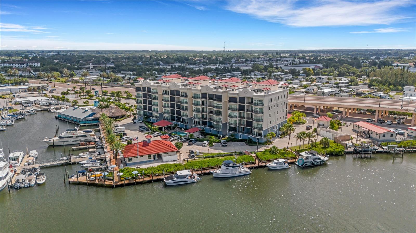 Fully Furnished. Located on the 5th floor of Porto Vista, one of Venice's newest condominium communities, this nearly 2,000 sq. ft. residence offers panoramic views of the Marina, Intracoastal Waterway, and Gulf of Mexico. Rarely used and custom finished throughout, the unit features 3 bedrooms, 2 bathrooms, luxury hardwood floors, 10-foot ceilings, solid wood doors, crown molding, plantation shutters, custom designed closets throughout the entire unit. The kitchen includes GE stainless steel appliances, quartz countertops, under-cabinet lighting, a custom exhaust hood, Timberlake solid wood cabinetry, an 11-foot peninsula, and a custom tile backsplash. The living and dining areas open to a private balcony with western exposure and water views. The primary suite features private lanai access, an oversized walk-in closet, and an ensuite bathroom with dual vanities and a custom walk-in Roman shower. Two additional bedrooms provide ample space for guests, a home office, or seasonal living. The residence includes a private enclosed one-car garage located beneath the building, secure elevator access from garage level, and abundant guest parking. Porto Vista is a 40-unit waterfront community. The 40 units include 4 ten unit buildings giving the Unit a wall of side windows. Additionally the privacy of only two units on each floor is rare. Amenities include a heated swimming pool, cabana, and poolside gazebo. Its location is one of the community's most desirable features. Residents are within a short walk of Historic Downtown Venice, where you'll find restaurants, shopping, entertainment, community events, and farmers markets. Venice Beach, the Venice Fishing Pier, marinas, golf courses, parks, and the Legacy Trail are all just minutes away. With waterfront views, custom finishes, a private garage, and a walkable location close to downtown and the beach, this residence offers an opportunity to own in one of Venice's most convenient and sought-after areas. Call and schedule your private showing today!