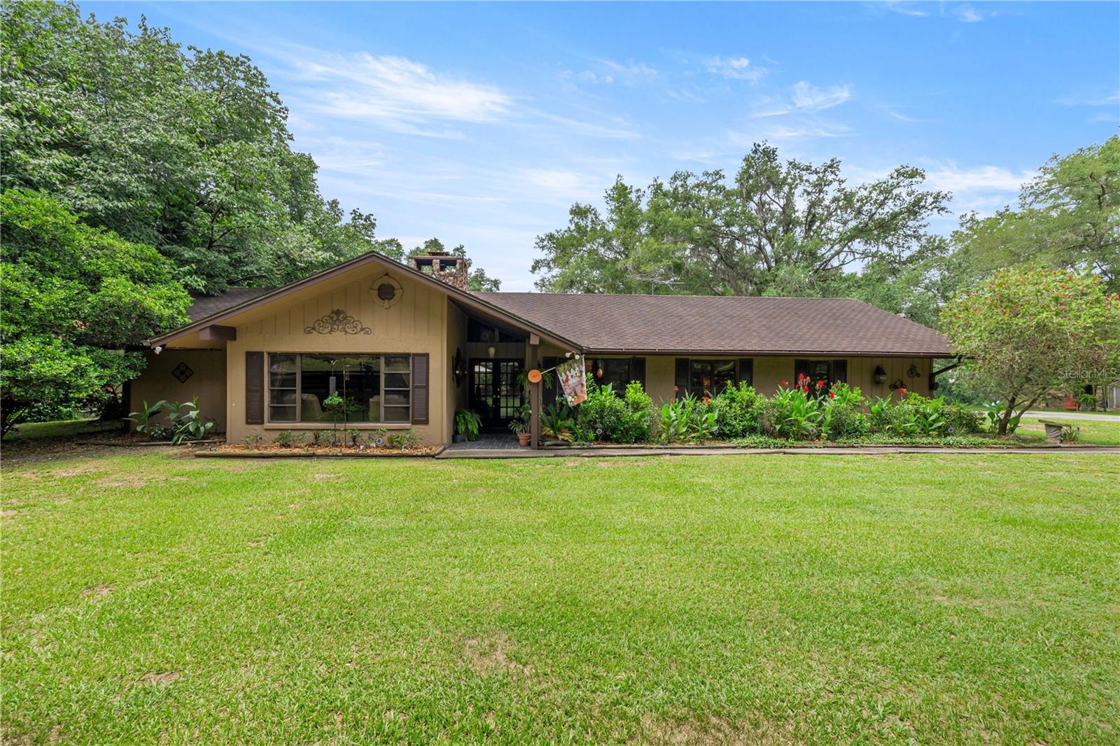 Welcome to your own private equestrian retreat just 8 miles south of Inverness! Nestled on 5 beautifully fenced and gated acres, this exceptional horse property offers the perfect combination of country living, comfort, and outdoor adventure. Whether you're an equestrian enthusiast, hobby farmer, multi-generational family, or simply looking for room to spread out and enjoy nature, this one-of-a-kind property delivers. The spacious 2140 square foot home features 3 bedrooms, 2 full bathrooms, and an inviting open-concept floor plan designed for both comfortable living and entertaining. The large living room flows seamlessly into the office area, kitchen, and dining spaces, creating a bright and welcoming atmosphere throughout. A stunning double-sided stone fireplace serves as the focal point of the home, providing warmth and character to multiple living areas. The kitchen features rich cherry cabinetry, Corian countertops, and ample storage and workspace for preparing meals and gathering with family and friends. A formal dining room offers additional space for holiday dinners and special occasions. Retreat to the spacious primary suite while the home's additional bedrooms provide plenty of room for family and guests. One bathroom features a luxurious jacuzzi tub, perfect for relaxing after a long day. Outdoor living takes center stage with a massive 14' x 40' screened porch accessible through two oversized 8-foot sliding glass doors. Step outside to the expansive 40' x 24' deck and partially in-ground pool complete with a shade sail, creating the ideal setting for entertaining and enjoying Florida's sunshine. For guests, extended family, or potential rental opportunities, the property includes a detached 20' x 12' guest/in-law suite complete with its own kitchen, half bath, and cable service. Horse lovers will appreciate the thoughtfully designed equestrian facilities featuring two barns with a total of 11 stalls, seven fenced pastures with water access, and quality four-board fencing throughout the property. The setup is ideal for boarding, training, breeding, or simply enjoying your own horses at home. The outdoor amenities continue with a charming gazebo, pergola, workshop, storage shed, and a unique treehouse connected by a 30-foot swinging bridge. The property also features mature fruit trees including peach, plum, olive, apple, grape, pomelo, lemon, tangerine, and kumquat. Additional features include a 2-car garage, 12' x 20' workshop, 10' x 12' storage shed, Spectrum fiber internet, multiple outdoor gathering spaces, and plenty of room for RVs, trailers, equipment, and recreational toys. Properties like this are hard to find, offering privacy, equestrian amenities, guest accommodations, and exceptional outdoor living. Schedule your private showing today and discover everything this extraordinary horse property has to offer.