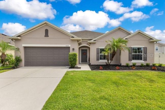 Welcome to this beautifully upgraded single-story home located on a premium corner lot in the highly desirable Sawgrass community. Offering 2,462 square feet of thoughtfully designed living space, this 3-bedroom, 2.5-bath residence features a spacious open-concept floor plan and an impressive list of custom upgrades throughout. The heart of the home is the gourmet kitchen, featuring soft-close cabinetry, abundant counter space, and a custom pantry shelving system designed for maximum organization. The open layout seamlessly connects the kitchen, dining, and living areas, making it ideal for both everyday living and entertaining. The private owner's suite offers a luxurious retreat with an extended walk-in shower featuring a custom-built seat and glass enclosure. Throughout the home you'll find tile flooring with no carpet, LED lighting, custom shelving in the hallway closet, a custom mudroom, surround sound in the living room, and a unique in-floor electrical outlet in the living room for added convenience. Work from home with ease in the dedicated office featuring elegant French glass doors. Enjoy whole-home audio with app-controlled music in four separate zones including the kitchen, primary suite, office, and lanai.
Step outside to enjoy Florida living at its finest. The extended screened lanai features dual ceiling fans and opens to an additional 10' x 20' paver patio, creating the perfect outdoor entertaining space. The fully fenced backyard offers plenty of room to play, along with an oversized double gate and dedicated dog run area. Additional upgrades include a 3-car tandem garage with insulated garage door, app-controlled garage access, overhead storage racks, 360-degree exterior camera system, Ring doorbell, alarm system, app-controlled sprinkler system, fiber optic internet, gutters surrounding the entire home, attic solar vent fan, UV air purification light in the HVAC system, and a new exterior A/C unit installed in 2024. The interior and exterior were freshly painted in 2026. Ideally located just minutes from Orlando International Airport, Lake Nona, Medical City, Brightline, SunRail, and major highways including SR-417, SR-528, and Florida's Turnpike, this home offers exceptional convenience for commuting and travel. Residents of Sawgrass enjoy outstanding community amenities including a resort-style pool, parks, tennis courts, basketball courts, bike area, picnic area, and dog park. Combining modern upgrades, functional living spaces, and an unbeatable location, this move-in ready home is a must-see.
