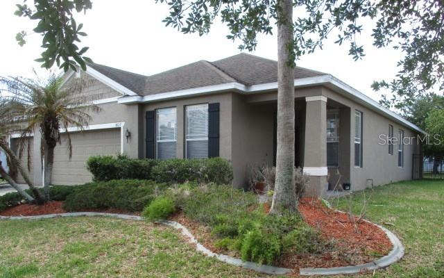 REO. Welcome home to 3827 Spirited Circle. This 4 bedroom, 2 full bathroom, 3 car garage home sits on an oversized lot of .26 acres with a fenced back yard.  This home features ceramic tile throughout overlooking the water, huge walk-in closet, double vanities in primary bathroom, plenty of recessed lighting, 42" ship-lap on walls of family room with barn doors, 8' front door, 8' sliding doors at rear of home leading out to a 15'x8' covered lanai over looking the water, and 10'-6" ceiling height throughout entire home.  Plenty of back yard space for a future pool ,and a huge 3 car garage with matching driveway for plenty of car parking. This home has no CDD and very reasonable property taxes and HOA fee, close to the turnpike onramp into down town Orlando (35 minute drive), community pool, community play ground, concrete sidewalks for exercise throughout community.   Homegenius Real Estate is Co-Broker