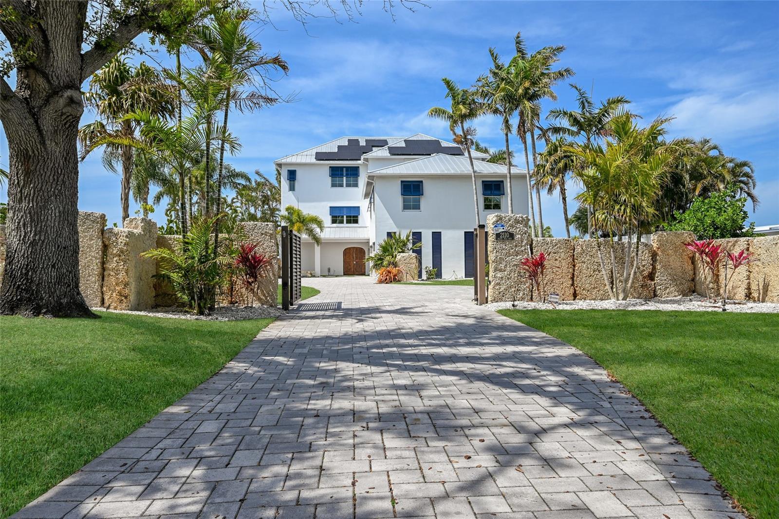 One or more photo(s) has been virtually staged. ABSOLUTELY STUNNING CUSTOM BUILT HOME DIRECTLY ON PALMA SOLA BAY WITH UNREAL NIGHTLY SUNSETS!!! This extraordinary coastal estate delivers a level of luxury, design, and waterfront living rarely found on Florida’s Gulf Coast. Built in 2015 by one of the West Coast’s premier luxury builders, this stunning residence offers 5 bedrooms, 4 full baths, 2 half baths, and a 4+ car garage, all thoughtfully designed with timeless coastal elegance and exceptional craftsmanship throughout. From the moment you enter, sweeping bay views create a breathtaking backdrop for the home’s light filled interior and open floor plan designed for both relaxed living and grand scale entertaining. The spectacular chef’s kitchen anchors the home with an oversized entertaining island, beautiful custom cabinetry, solid stone countertops, a shimmering mother of pearl backsplash, and professional grade appliances including an eight burner gas range with double ovens. The expansive great room is equally impressive, featuring a fireplace and a full wall of sliding glass doors that seamlessly connect the interior living space with the outdoor environment while framing incredible waterfront views. Luxury amenities throughout the home include extensive millwork, integrated audio system, central vacuum, SAUNA, keypad entry, and a PRIVATE ELEVATOR. Designed for both comfort and efficiency, the residence is also equipped with HURRICANE IMPACT WINDOWS and a SOLAR PANEL SYSTEM capable of powering the entire home, offering both peace of mind and long term energy efficiency. The upper level showcases a tranquil waterfront primary suite with breathtaking views of the bay and a luxurious spa inspired bath featuring a deep soaking tub, glass walk in shower, and dual vanities. Multiple covered balconies with cypress wood plank ceilings and recessed lighting provide stunning spaces to enjoy coastal breezes and unforgettable sunsets. The outdoor living experience is nothing short of spectacular. Designed to feel like a private waterfront resort, the backyard features lush tropical landscaping, towering palms, and an incredible RESORT STYLE pool with dramatic waterfall feature, all surrounded by an expansive Ipe wood deck, full outdoor kitchen, and a pool bath creating the ultimate setting for entertaining or relaxing in total privacy. Boating enthusiasts will appreciate the impressive newly constructed 700-foot dock with two lifts and additional floating dock for easy access providing exceptional boating capabilities and effortless access to Sarasota Bay and the Gulf. This is a rare opportunity to own one of the most impressive waterfront estates along coveted Palma Sola Blvd, where luxury living, breathtaking views, and resort inspired outdoor spaces come together to create an extraordinary coastal retreat only minutes from Anna Maria Island! DO NOT WAIT ON THIS ONE!!!