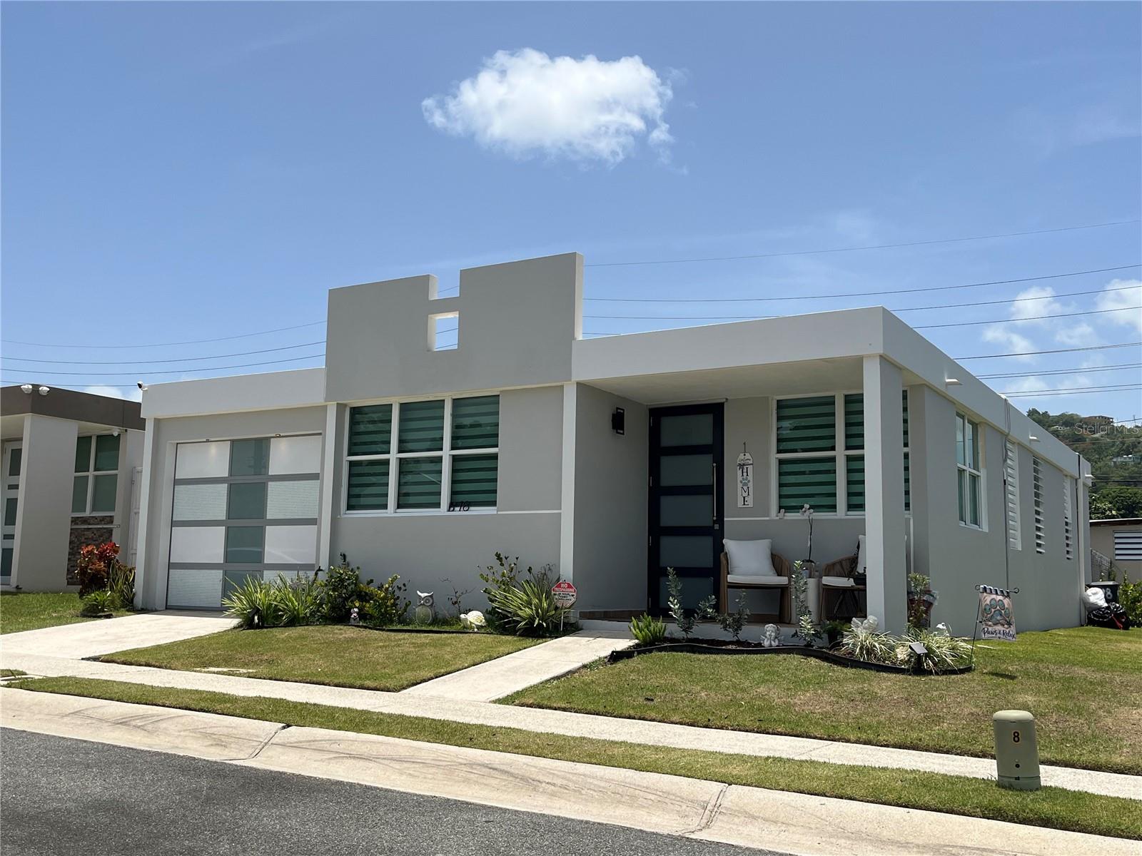 Beautiful residence located in the Urb. Arboleda neighborhood of Humacao. This gated community features a swimming pool, basketball court, clubhouse, and walking areas. The home features 3 bedrooms, 2 bathrooms, a living room, dining room and a recently remodeled kitchen equipped with PVC cabinets, an electric cooktop, a counter-depth side-by-side refrigerator, washer, dryer. Additional features include an extended carport for 2 cars, 3 A/C units (2 of 12,000 BTU and 1 of 24,000 BTU), ceiling fans, and various ceiling and wall light fixtures. Move-in-ready. Its strategic location provides residents with quick access to essential service, local schools, and mayor transit routes. Just minutes from Expressway 53 and Route 3.