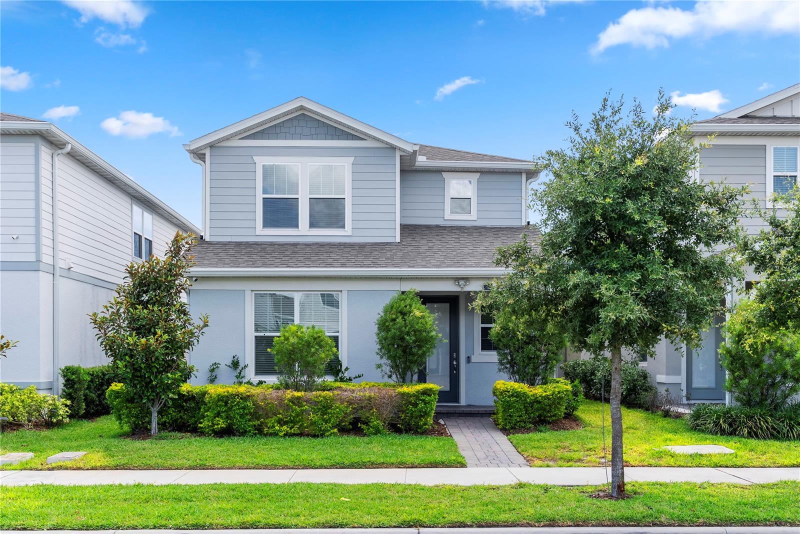 Experience modern luxury and low-maintenance living in this impressive Monterey model located within the highly desirable gated community of Isles of Lake Nona. Offering approximately 2,191 square feet of thoughtfully designed living space, this residence combines upscale finishes, functional design, and exceptional indoor-outdoor living in one of Central Florida’s most sought-after locations. The welcoming foyer opens to a spacious and open-concept layout designed with both comfort and entertaining in mind. The first-floor primary suite provides a private retreat complete with a spacious walk-in closet and an elegant en-suite bathroom featuring dual vanities and a large glass-enclosed shower. The heart of the home is the beautifully appointed kitchen, showcasing upgraded 42-inch cabinetry, quartz countertops, wood-look ceramic tile flooring, and an oversized island that flows seamlessly into the dining and living areas. Sliding doors lead to the covered lanai, creating the perfect space to relax or entertain outdoors, while the attached 2-car garage features a durable epoxy-coated floor for added style and convenience. Upstairs, a spacious loft offers flexibility for a media room, game area, or additional living space, along with generously sized secondary bedrooms and access to a private rooftop deck ideal for enjoying Florida evenings. Additional upgrades include custom blinds, an ADT security system with cameras, smart home pre-wiring, gigabit fiber internet connectivity, and exterior weatherproofing designed for enhanced durability and easy maintenance. For added convenience, all furnishings are included, making this a truly move-in-ready opportunity. Residents of Isles of Lake Nona enjoy access to exceptional resort-style amenities including a community pool, clubhouse, fitness areas, sports courts, playgrounds, and beautifully maintained green spaces. Ideally positioned just minutes from Medical City, Lake Nona Town Center, Orlando International Airport, major highways, dining, shopping, and entertainment, this home offers the perfect combination of luxury, location, and lifestyle.