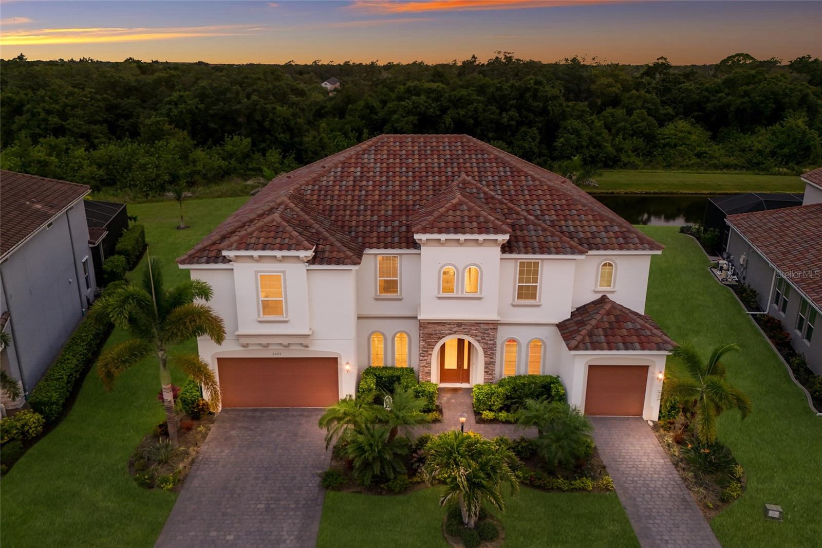 WELCOME to this STUNNING Tortuga model by Meritage Homes, offering over 5,151 square feet of thoughtfully designed living space in the highly sought after community of Savanna at Lakewood Ranch. Boasting 8 bedrooms, 4 bathrooms, and a 3 car garage, this exceptional residence provides the perfect combination of LUXURY, comfort, and functionality for today’s modern family. As you step through the front door, you’re welcomed by an ELEGANT formal dining room and a versatile FLEX space ideal for a home office, sitting room, or study. The open concept design seamlessly connects the spacious living areas, creating an inviting atmosphere for both everyday living and entertaining. The gourmet kitchen features abundant cabinetry, granite countertops, tile backsplash, stainless steel appliances, a BRAND-NEW BUILT-IN microwave/oven combination, cooktop, walk-in pantry, and an oversized island with seating and a sink, making it the heart of the home. Adjacent to the kitchen is a casual dining area with beautiful views of the pool through sliding glass doors. The expansive family room overlooks the outdoor living space and provides the perfect setting to relax and unwind. Conveniently located on the first floor, the primary suite offers PRIVATE access to the lanai and pool area through sliding glass doors. The ENSUITE bathroom features dual vanities, a walk-in tiled glass shower, a soaking garden tub, and generous closet space. Also located downstairs is an additional bedroom and full bathroom, ideal for guests and conveniently serving as a POOL BATH. Upstairs, you’ll discover an impressive OVERSIZED LOFT offering endless possibilities for a game room, playroom, home gym, or additional living space, along with a separate MEDIA ROOM that creates the perfect setting for movie nights and family gatherings. Six additional bedrooms and two full bathrooms with dual vanities and tub/shower combinations provide ample accommodations for family and guests. For added convenience, the home is equipped with TWO LAUNDRY ROOMS, one on each level, and offers abundant storage and closet space throughout. Step outside to your PRIVATE backyard OASIS where an extended covered paver lanai overlooks a HEATED free-form SALTWATER POOL and SPA complete with multi-color LED lighting. The fully SCREENED outdoor living area offers abundant space for entertaining, dining, and relaxing while enjoying peaceful pond views and breathtaking Florida sunsets. Additional LANAI LIGHTING enhances the ambiance, making it the perfect space to enjoy day or night. The backyard has been beautifully enhanced with updated landscaping, mature palm trees, and privacy palms, creating a tranquil TROPICAL retreat. Gas and water lines are already in place for a future outdoor kitchen, while the home is PRE-WIRED for surround sound in both the family room and game room. With exceptional living space, premium upgrades, and resort-style outdoor amenities, this remarkable home truly has room for everyone and is ready to welcome its next family. Savanna is a fabulous community with LOW HOA resort-style amenities such as a clubhouse, swimming pool, state-of-the-art fitness center, basketball courts, playground, dog park and numerous walking paths. Lakewood Ranch is known for their A+ rated school system and is perfectly located just a short ride to downtown Sarasota, St. Pete, world class shopping, fine dining and the FAMOUS Gulf beaches! Don't wait to make this your HOME and begin your FLORIDA Lifestyle!