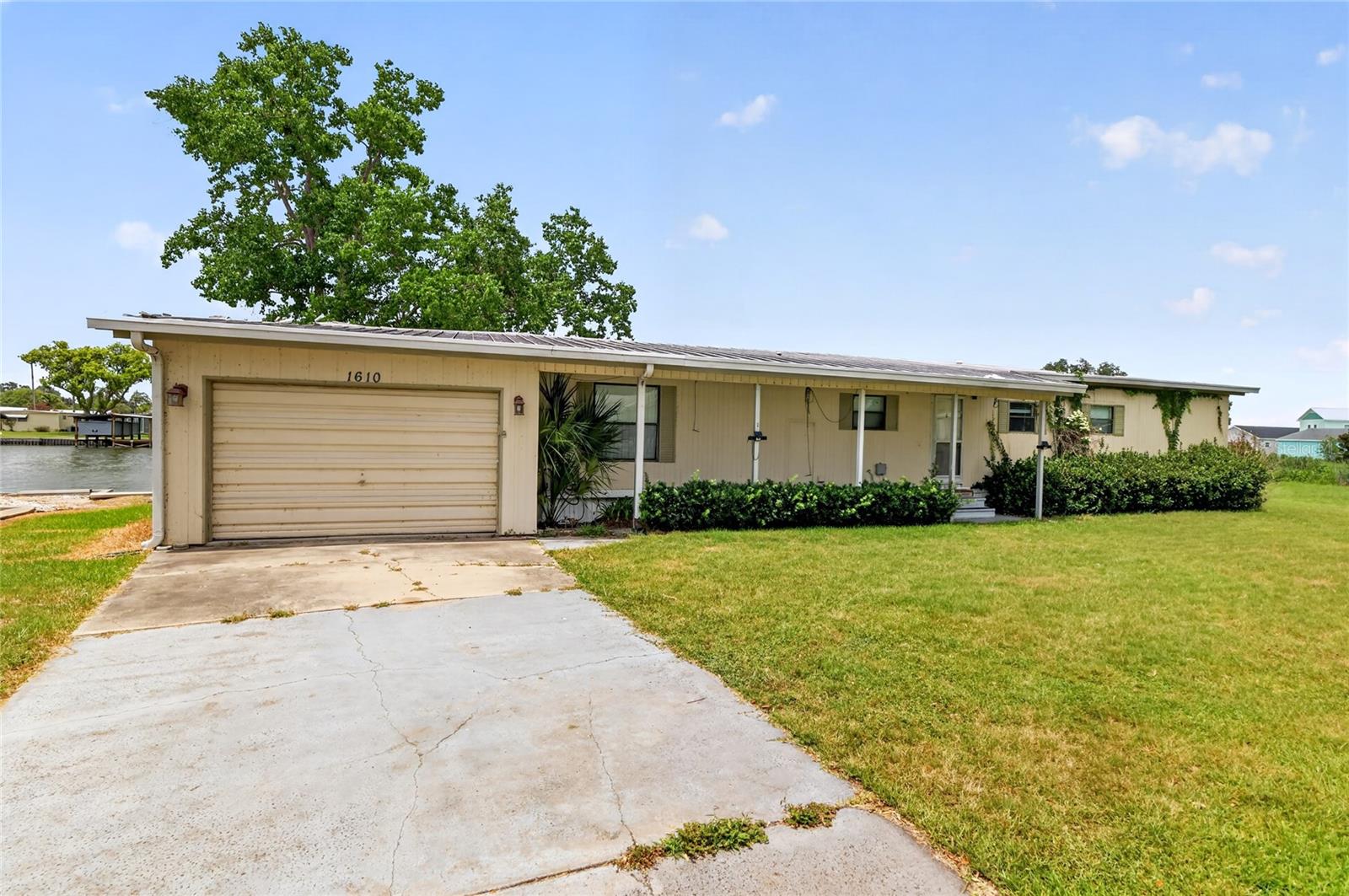 Welcome to waterfront living moments from the Dora Canal and Downtown Tavares on Lake Dora!  This 1983 manufactured home has had some updates; Newer kitchen cabinets, countertops and appliances, site built oversized garage/workshop; but still needs some TLC.   With just under 150' of Canal / Lagoon frontage and Lake View of Lake Dora, this home is priced in the money!  There is an existing covered boat dock but the deck leading to it needs replacement.  Inside the home, you have a large living room with attached oversized lanai with amazing water views!  The family room boasts unobstructed Lake Views and a small dinette just between it and the updated kitchen.  Two bedrooms, two baths and an inside laundry make this a year round home!  NO HOA, NO 55+ RESTRICTIONS make this a unique home with plenty of opportunity for everyone!   This home is a short walks distance to the City of Tavares 40+ acre public water front park within the community.  Publix sits just across the road from the community along with additional shopping and dining and Downtown Tavares is just a 5 minute drive away!  City water and City sewer are a plus along with a newer AC.  Come enjoy the Lake Life from this affordable home!