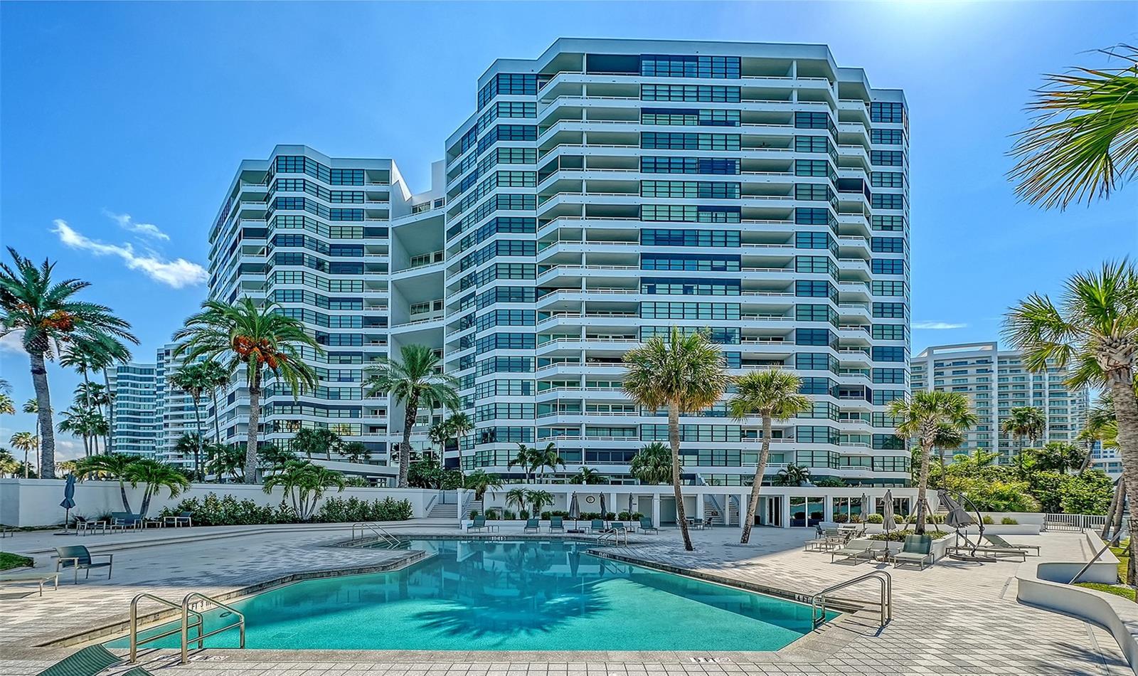 If you've been torn between the privacy of a single-family home and the convenience of luxury condominium living, this exceptional terrace-level residence offers the best of both worlds. One of the community's most coveted locations, it features a private, garden-like terrace with walkout access, creating the feeling of a waterfront home while enjoying the ease of maintenance-free living.Framed by breathtaking, unobstructed views of Sarasota Bay, this residence was thoughtfully designed to maximize natural light, open living spaces, and the spectacular waterfront setting. Expansive living and dining areas flow effortlessly to the oversized private terrace, inviting seamless indoor-outdoor living for morning coffee, sunset cocktails, or entertaining against an ever-changing backdrop of sparkling water.The spacious bedroom suites provide peaceful retreats, each offering beautiful natural light and tranquil views that inspire relaxation every day.
Residents enjoy an unparalleled lifestyle within this direct waterfront community, renowned for its resort-caliber amenities, including two heated swimming pools, tennis courts, a state-of-the-art fitness center, private boat docks, covered parking, 24-hour security, and impeccably landscaped tropical grounds.Perfectly positioned just minutes from downtown Sarasota, The Bay Park, waterfront dining, shopping, art galleries, and world-class cultural attractions, this extraordinary residence combines an unrivaled location with an exceptional lifestyle. Best of all, your panoramic Sarasota Bay views and spectacular sunsets are permanently protected, with no future development ever able to rise in front of you. This is waterfront living at its finest.